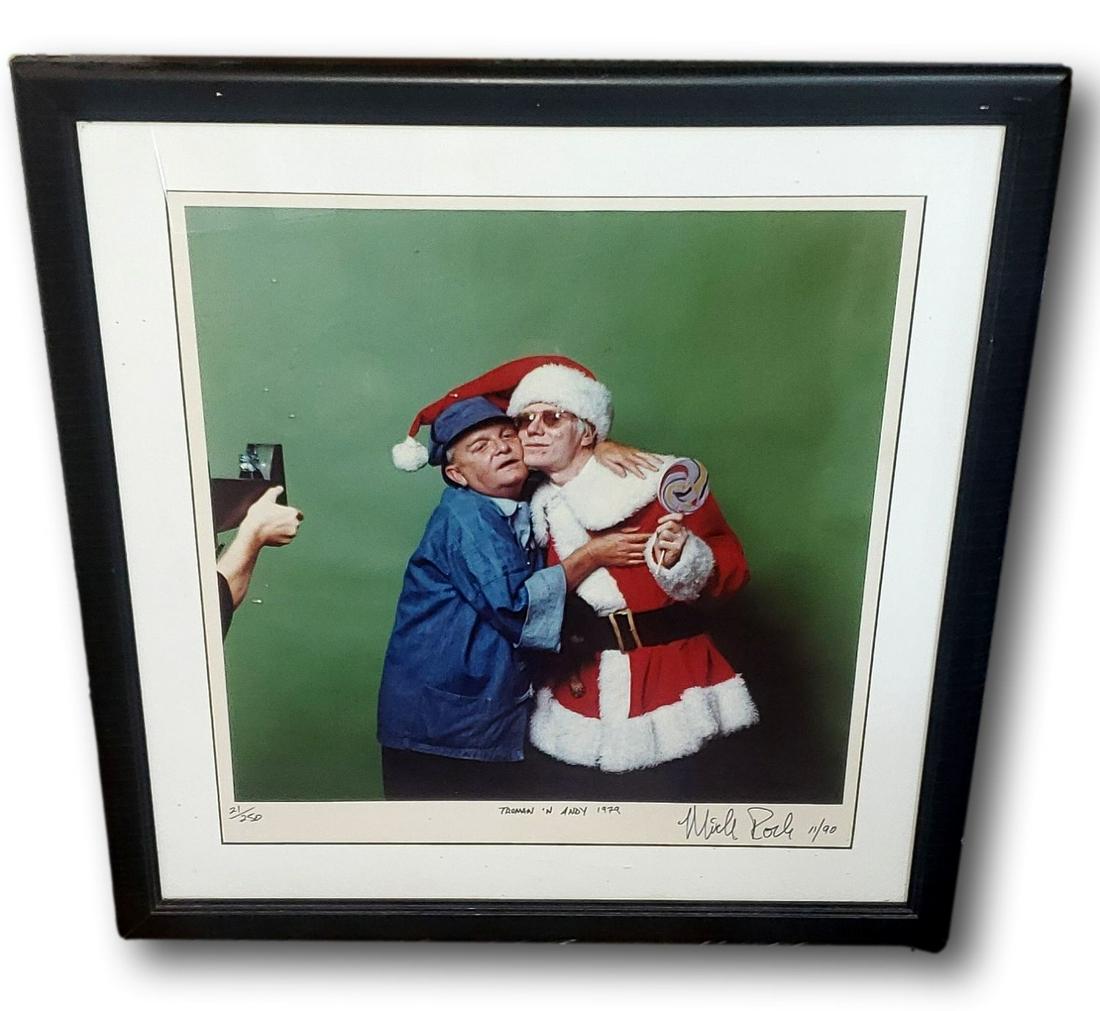 Mick Rock Signed Photograph of Andy Warhol and Truman Capote: This is a hand signed, dated, titled, and numbered photograph taken by Mick Rock and used for the December 1978 issue of High Times. The identity of the two models masquerading as Santa Claus and one