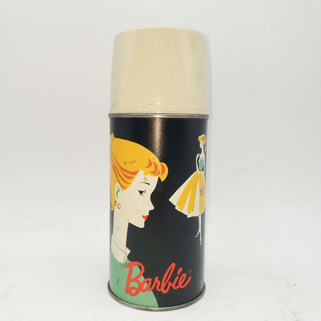 Vintage 1962 Barbie Thermos with Cap and Cup: The thermos is in good condition. No cracks (inside or out) and the color is vibrant. - â€“ Provenance: CJ Collection â€“ Detailed condition reports are not included in this cata