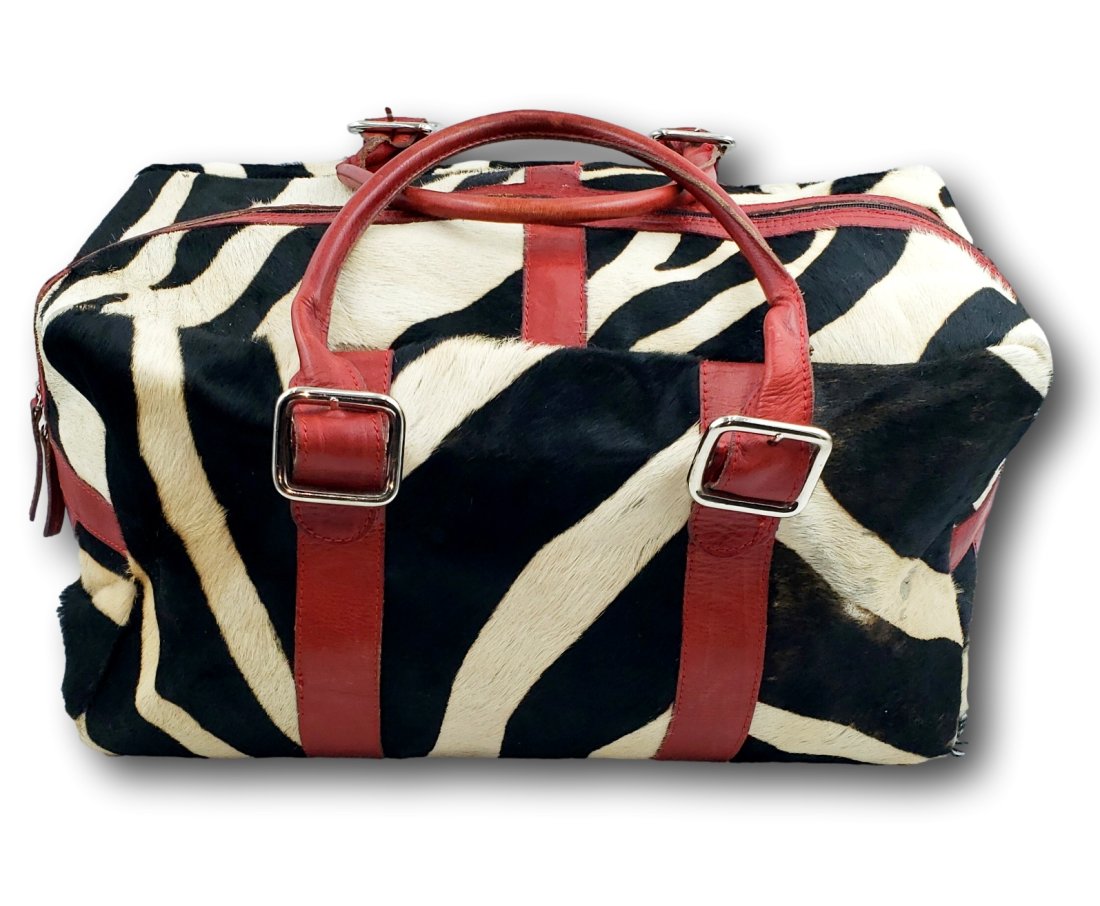 Vintage Zebra Skin Travel Bag: Step back in time with this authentic vintage travel bag, boasting a bold zebra skin exterior. This statement piece reflects a bygone era of travel when luggage was not just functional but a symbol of