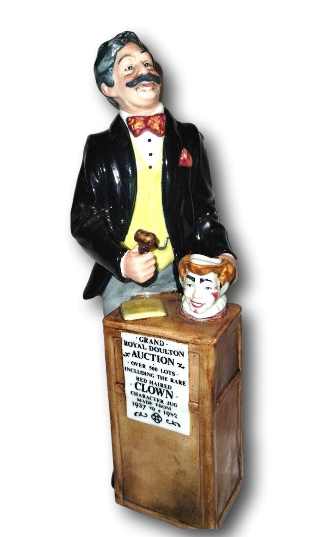 The Auctioneer . Vintage Royal Doulton HN 2988. Retired in 1986: This Royal Doulton figurine, titled "The Auctioneer" (HN 2988), is a hand-painted bone china collectible from 1986. The charming figurine depicts a man in a multicolored outfit and is finished with a 