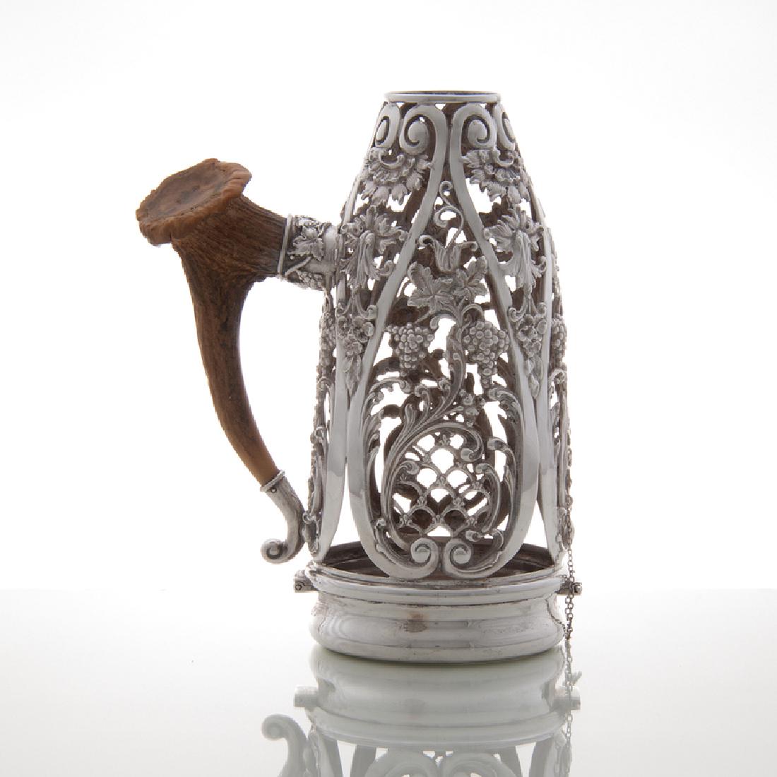 American Sterling Wine Bottle Holder with Antler Handle: American, late 19th-early 20th century. A sterling wine bottle holder retailed by Cowell & Hubbard of Cleveland, having grape vine design and antler handle, marked for retailer and STERLING on unders