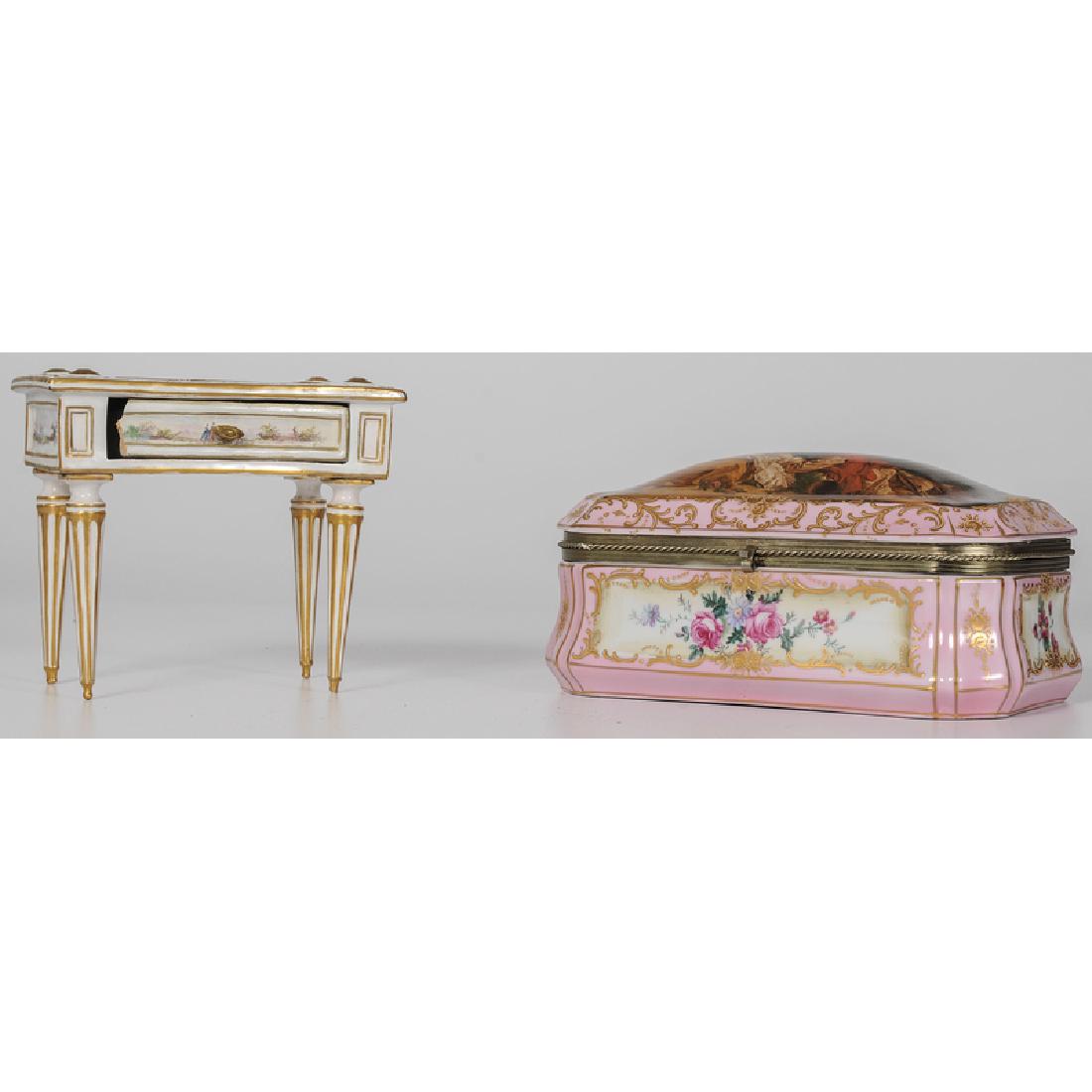 Marseilles Faience Diminutive Desk and Porcelain: French, late 18th and 20th century. A faience diminutive neoclassical desk decorated with figural reserves and painted with two marks to underside, and a gilt porcelain jewelry casket, the lid decora