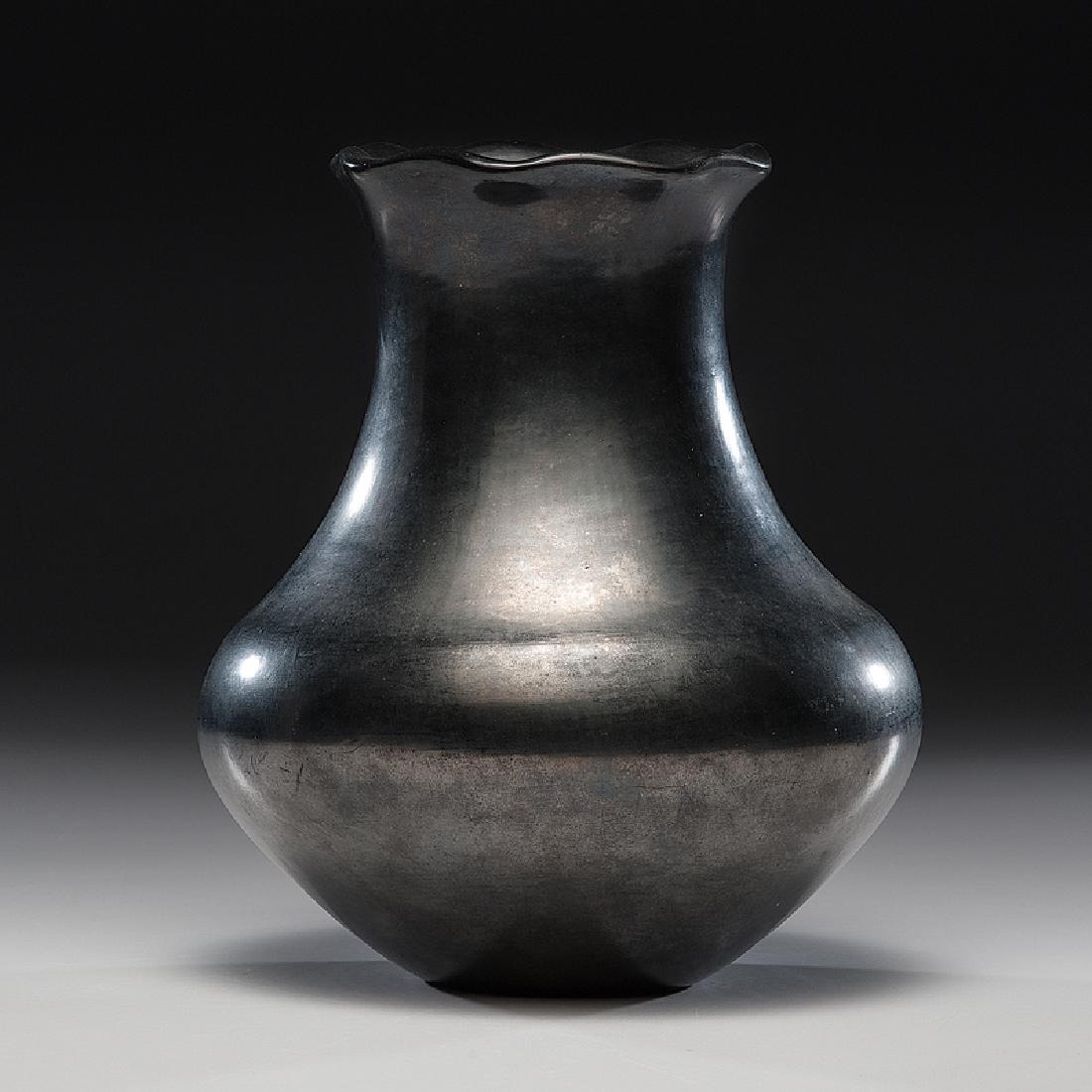 Maria Martinez (San Ildefonso, 1887 - 1980) Pottery: gun metal finish and with ruffled rim, signed Maria Poveka and dated on base, height 9.25 in. x diameter 7.5 in.October 1963 Provenance: From the Estate of Clem Caldwell