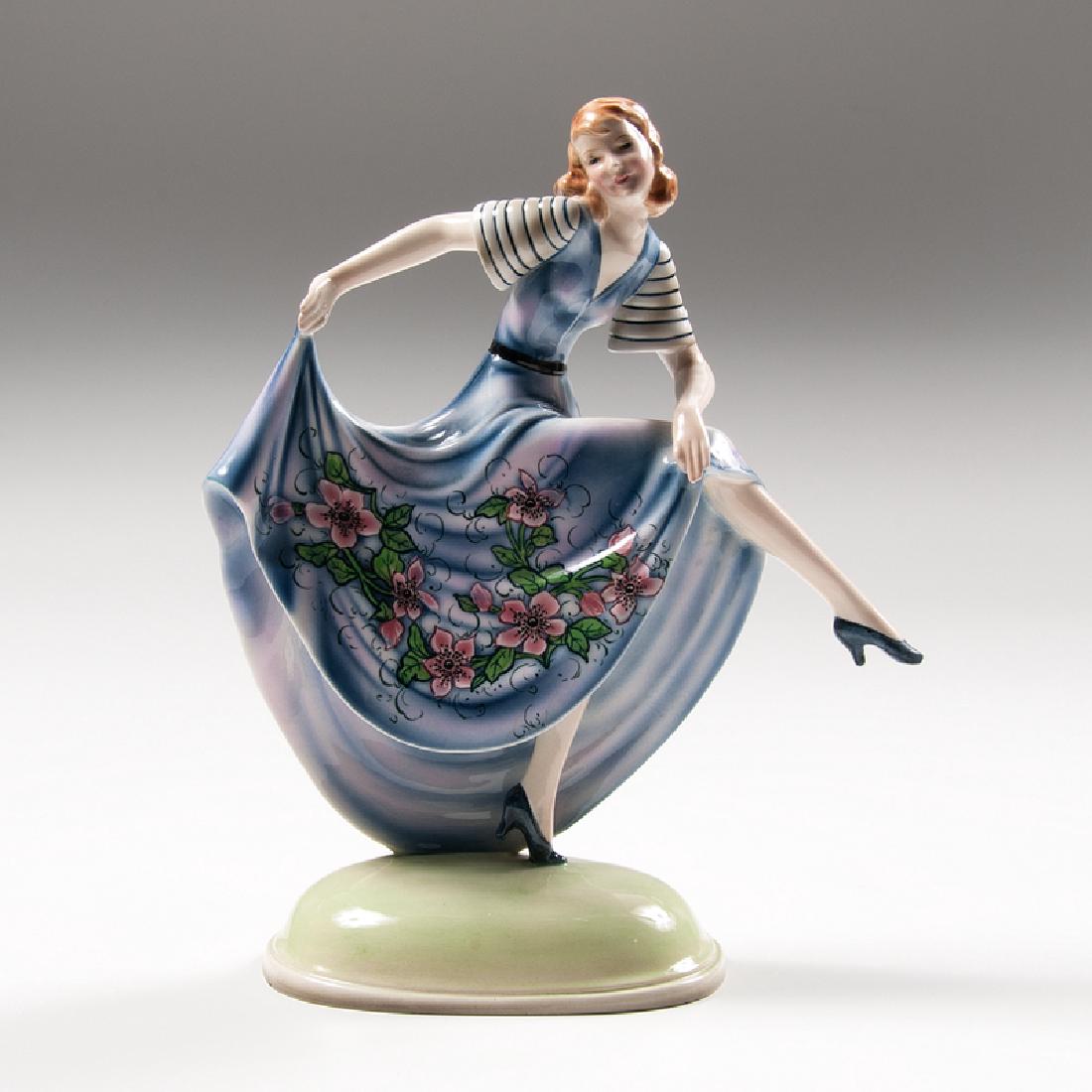Stefan Dakon (Austrian, 1904-1997) for Goldscheider: Austria, ca. 1932. A porcelain figure by Stefan Dakon for Goldscheider depicting a dancer on tiptoe holding her skirts, with manufacturer's mark and impressed 6704 / 2 on underside; ht. 12.25, wd.