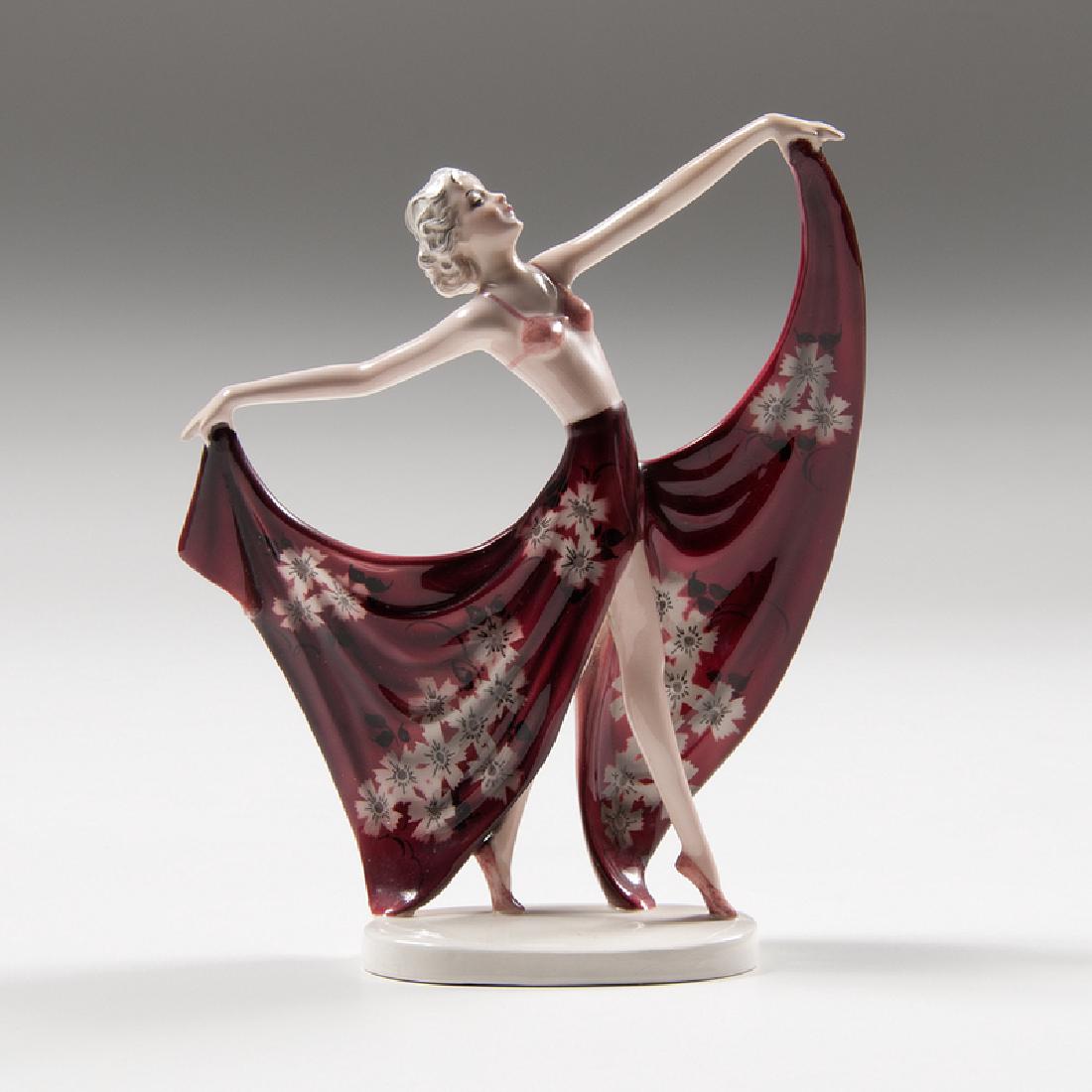 Stefan Dakon (Austrian, 1904-1997) and Josef Lorenzl: Austria, ca. 1937-1938. A porcelain figure by Stefan Dakon and Josef Lorenzl for Goldscheider titled "Champagne" depicting a dancer on her toes holding her skirts out in both hands, with manufactu