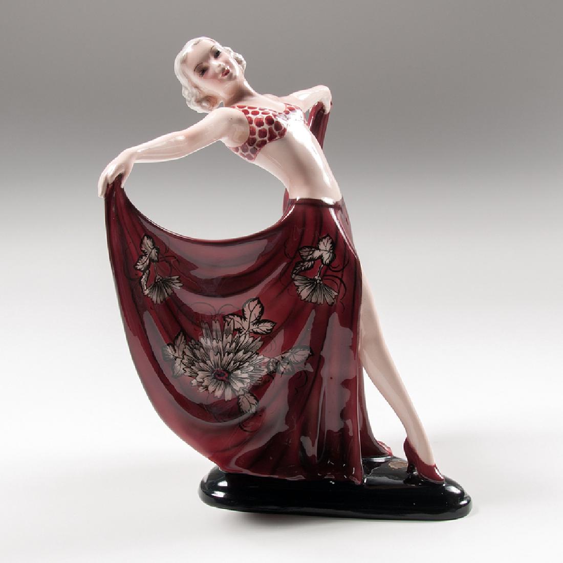 Josef Lorenzl (Austrian, 1892-1950) for Goldscheider: Austria, ca. 1937. A porcelain figure by Josef Lorenzl for Goldscheider depicting a dancer in a split skirt, with manufacturer's mark on underside, original manufacturer's sticker on top of base, st