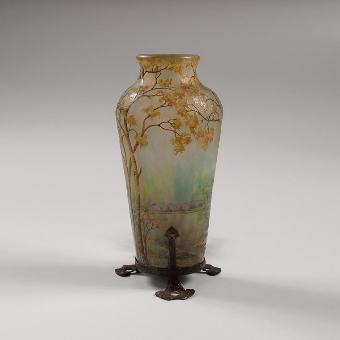 Glass Landscape Vase Mounted as Lamp attributed to Daum: France, early 20th century. A cameo glass vase attributed to Daum, decorated with a spring landscape scene with trees and a lake in the background, mounted on a metal lamp base, unmarked; ht. 9.25, w