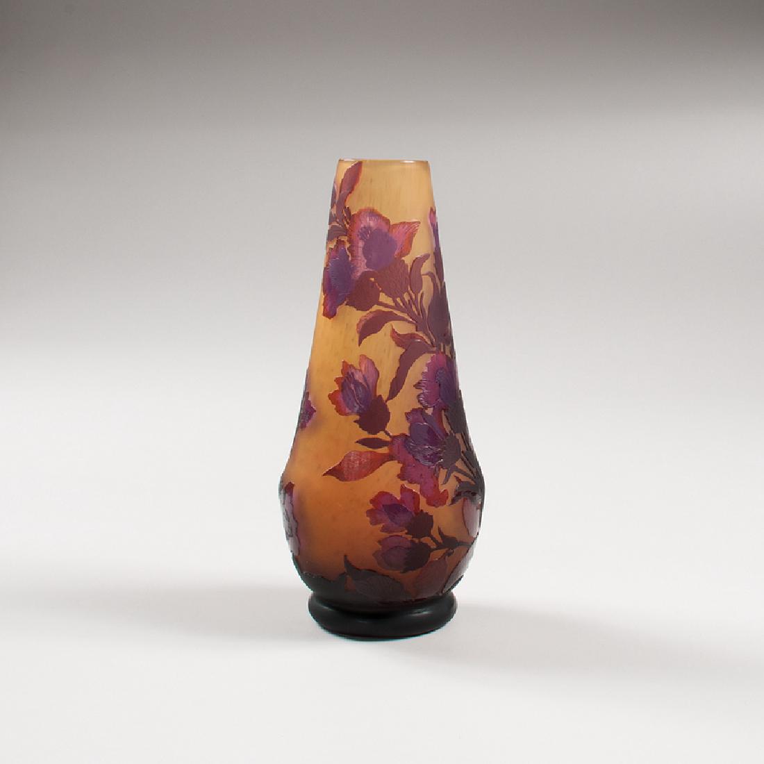 Daum Nancy Cameo Vase: France, early 20th century. A cameo glass vase by Daum Nancy, with yellow glass and purple flower design, marked on the lower half Daum Nancy and with the Cross of Lorraine; ht. 10.75, dia. 4.75 in.