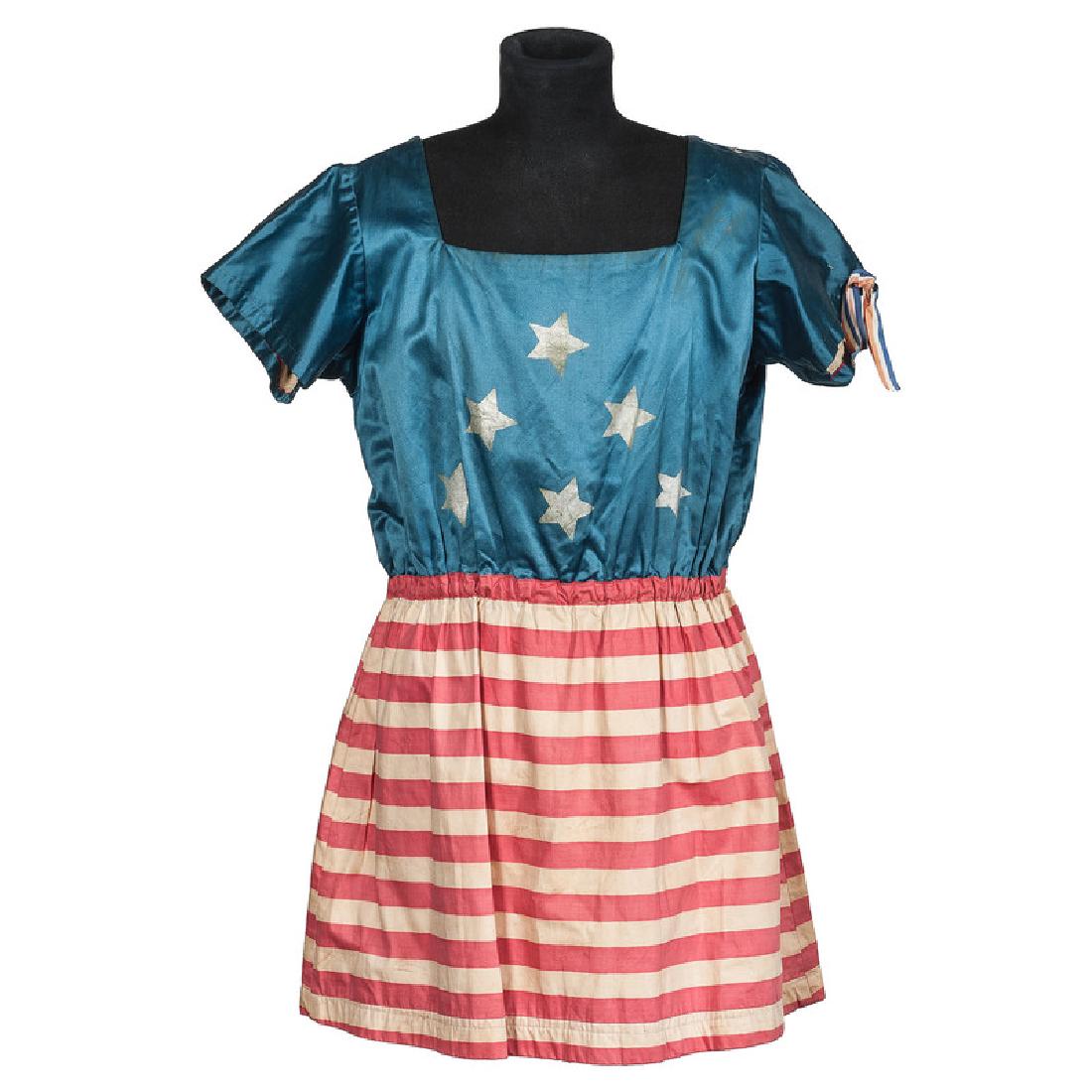 19th Century Women's Satin Patriotic US Flag Costume: Machine-sewn, with blue top decorated with six silver painted stars, puckered waist, and red and white printed polished cotton skirt; dress lined with cotton, length 33 in. x chest 38 in. This was lik