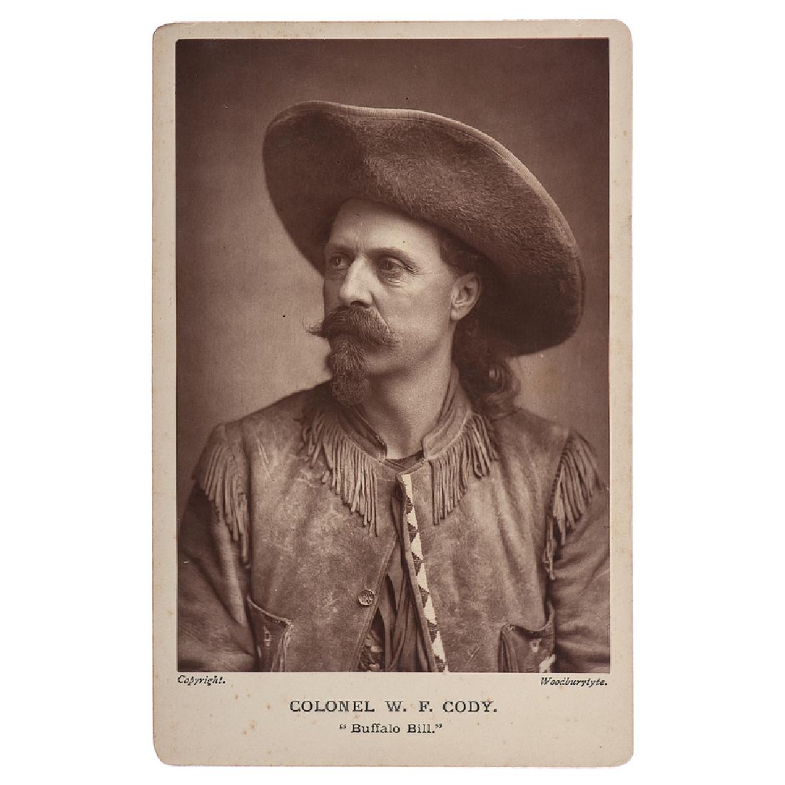Scarce Buffalo Bill Woodburytype Cabinet Card: Fine Woodburytype cabinet card portrait of Cody wearing his trademark Stetson and a fringed buckskin jacket with beaded trim. This image, taken during Buffalo Bill's 1887 tour of England and Europe,