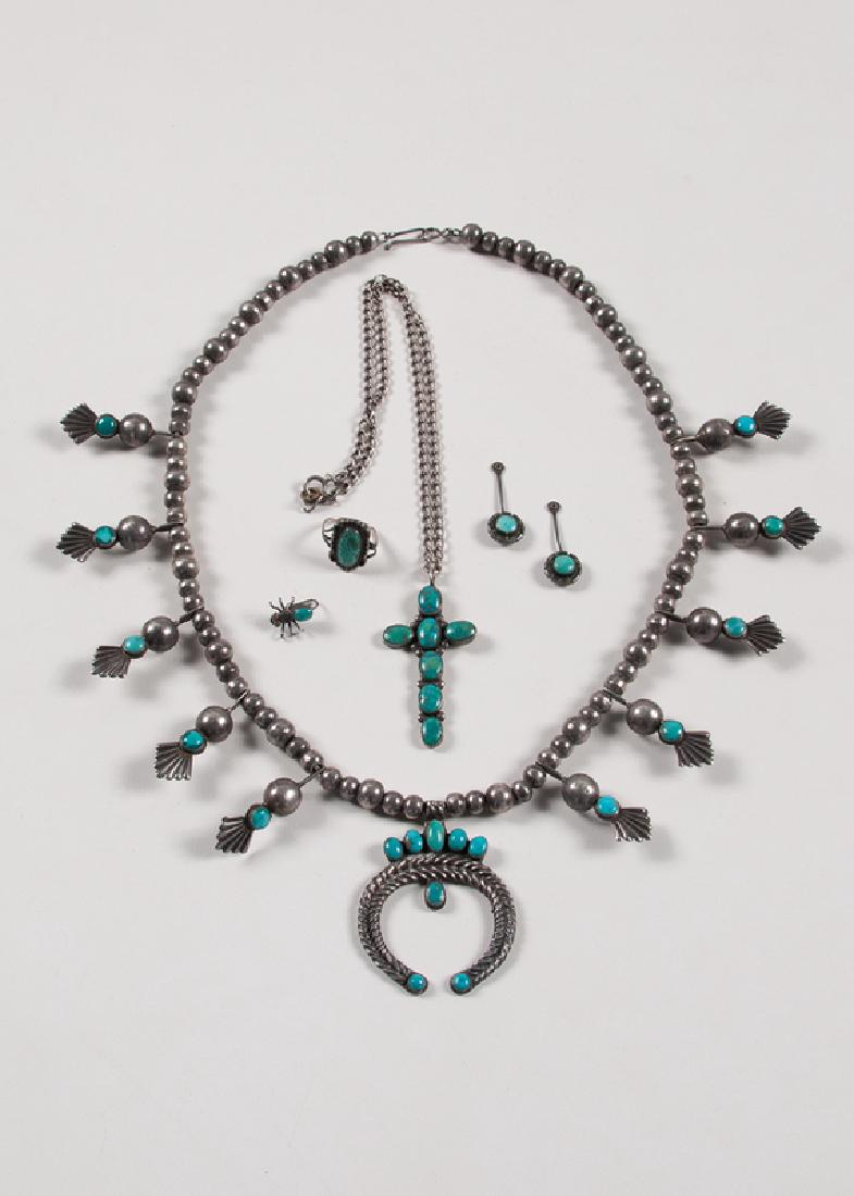 Silver and Turquoise Jewelry: American, 20th century. A group of six pieces of silver and turquoise jewelry, including:Â one squash blossom necklace;Â one necklace with cross pendant;Â one pair of circular earrings;Â o