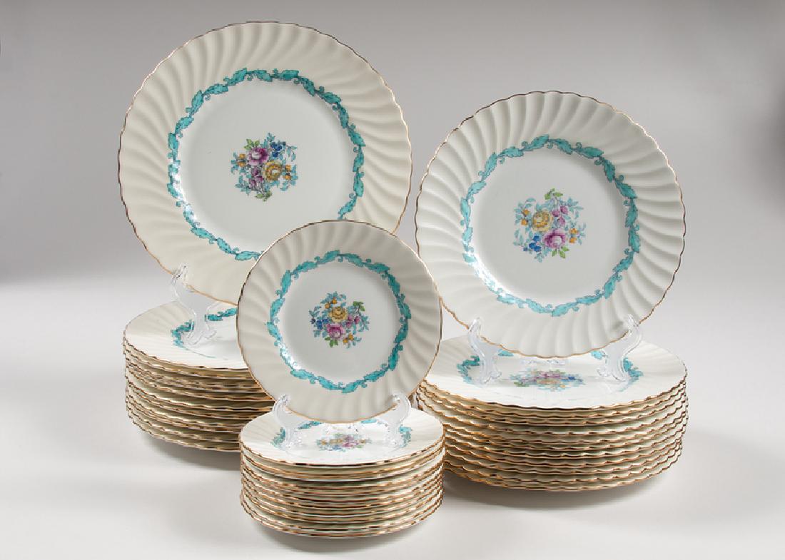 Minton Ardmore Plates: British, mid-20th century. A group of thirty-six plates by Minton in the "Ardmore" pattern, having off-white ground and enamel floral decoration in the center. Includes twelve dinner plates, twelve sa