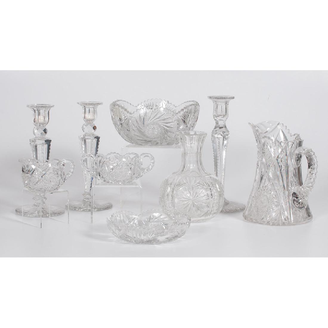 Assorted Cut Glass Table Wares: American, 20th century. A group of nine cut glass items including a pitcher, a creamer, a handled bowl, a serving bowl, a tray, a vase, and three candlesticks, all unmarked; largest ht. 10.75 in., ser