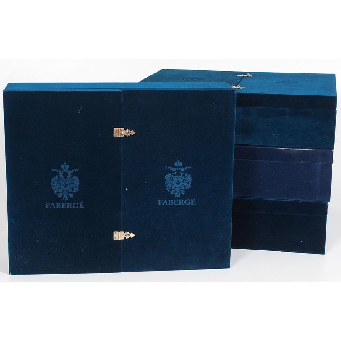 Faberge Cobalt Wine Glasses: 21st century. A set of cobalt cut to clear crystal wine glasses, twenty-four in total, in two sizes, all with etched marks and in original cases; larger ht. 9 in. (each), smaller ht. 8.25 in. (each). 