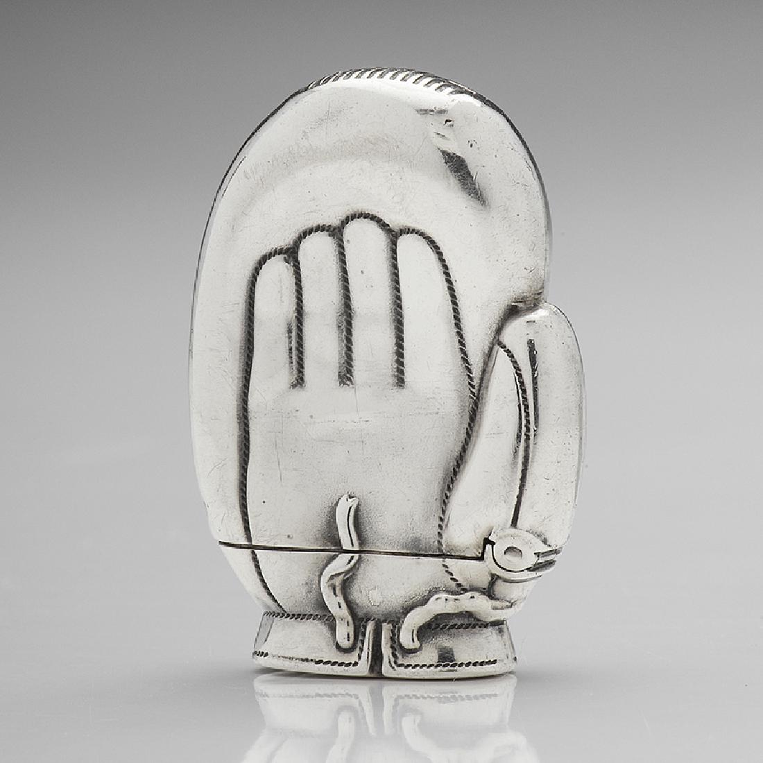 Glove Form Match Safe: Late 19th century. A silver match safe in the form of an 1890s-style boxing glove, unmarked; ht. 1 5/8, wd. 1 1/8 in.