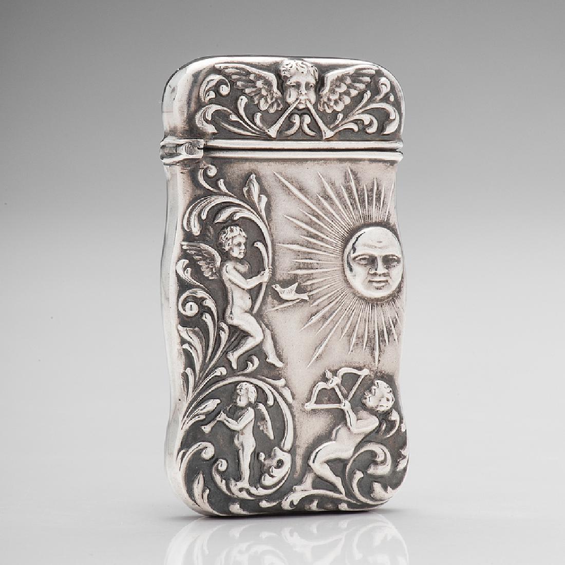 Cherubs and Sun Sterling Match Safe: American, late 19th-early 20th century. A sterling silver match safe decorated on both sides with three cherubs and the sun, marked on interior rim; ht. 2 1/2, wd. 1 5/8 in.