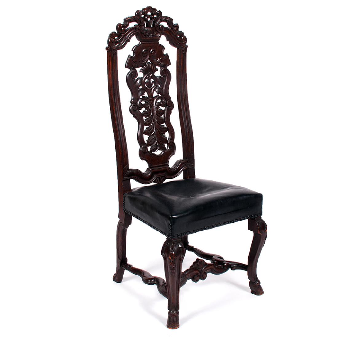 William and Mary Hall Chair in Oak: Late 17th-early 18th century. An ornately carved William and Mary hall chair in oak, having a pierced crest and back splat, leather seat, and rising on cabriole legs ending in hoof feet; ht. 50, wd. 