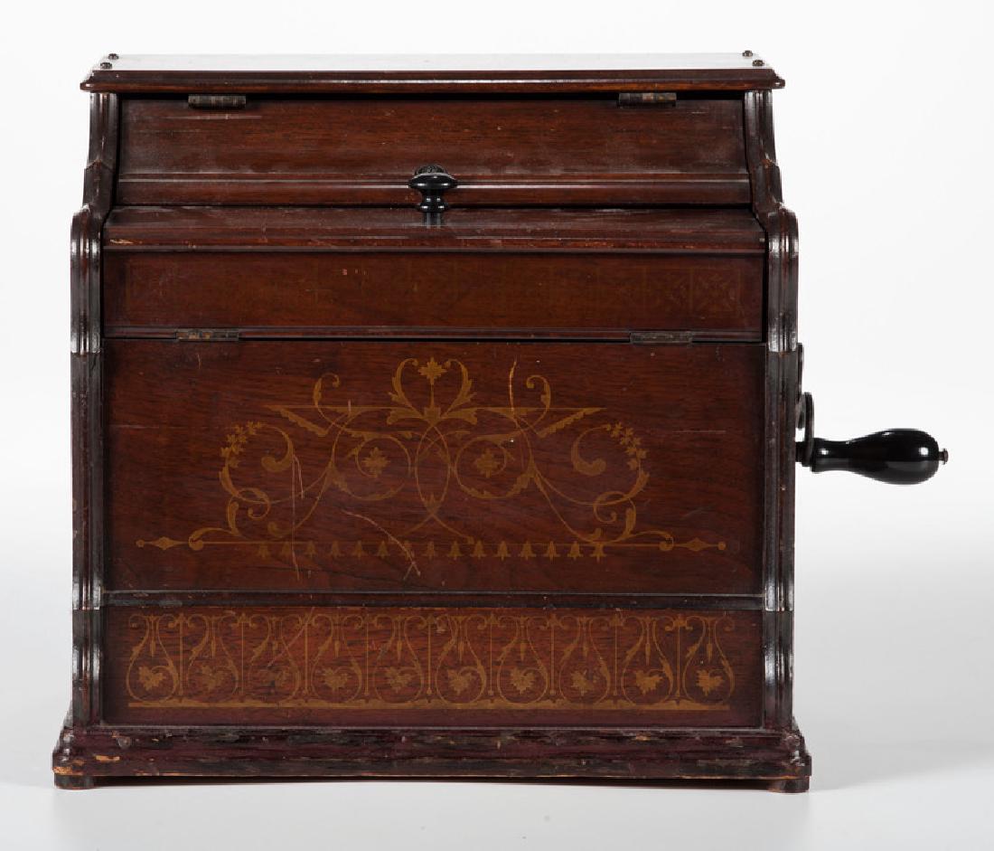 Melodia Paper Roller Organ: American. A paper roller organ with hand crank on side and stencil-decorated case. One paper roll included; ht. 11.5, wd. 12, dp. 10 in.