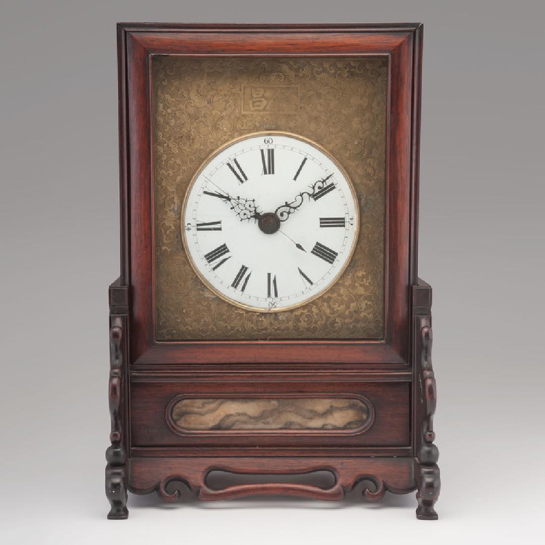 Chinese Screen Shelf Clock: Chinese, mid-19th century. A shelf clock with eight-day movement, quarter striking on two bells, in a wooden case with porcelain dial and decorative brass surround. Character marks to movement back pl