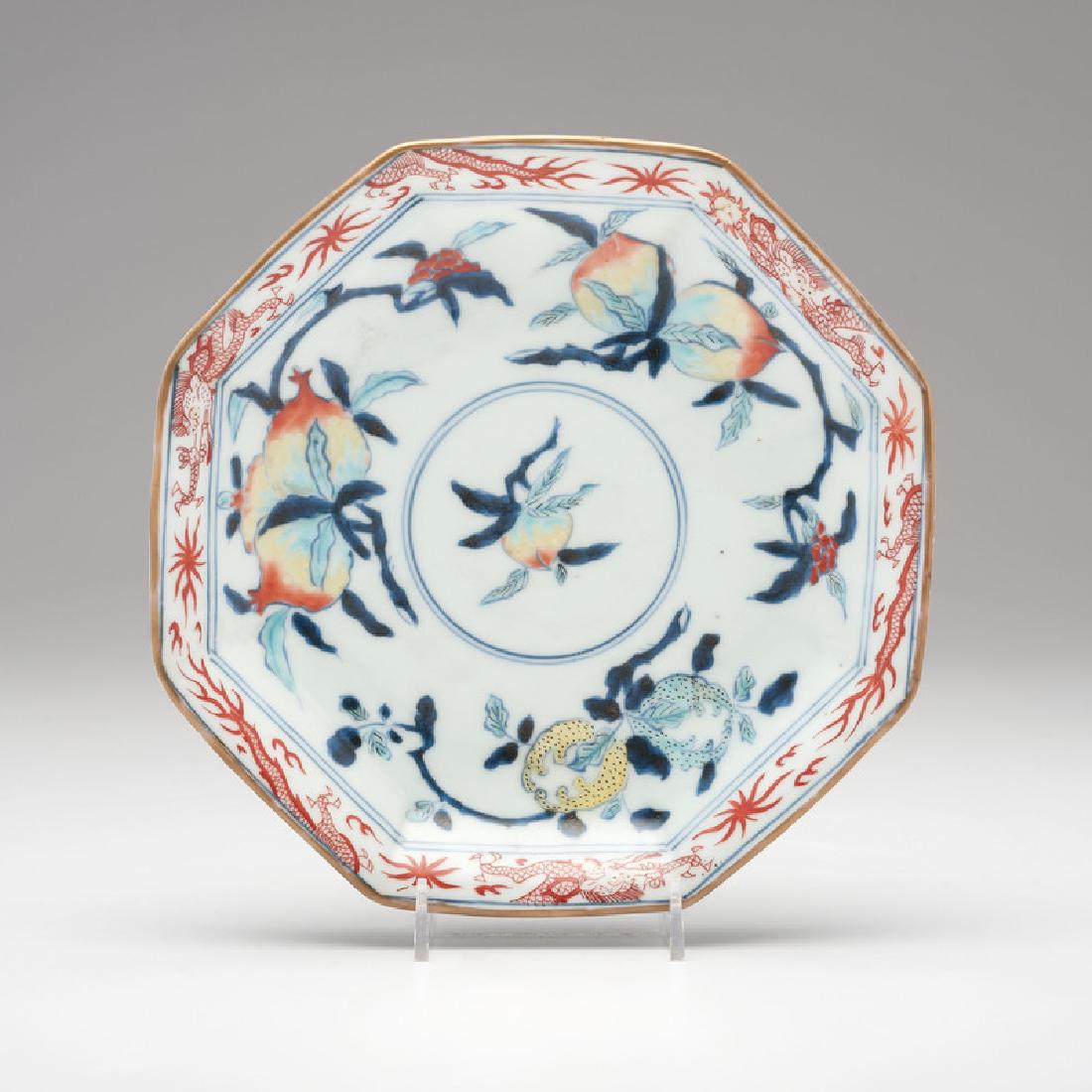 Chinese Dish with Peach Decoration: Chinese. An octagonal porcelain plate decorated with peaches on the branch, with dragon border, six character mark to underside; wd. 7.75 in.