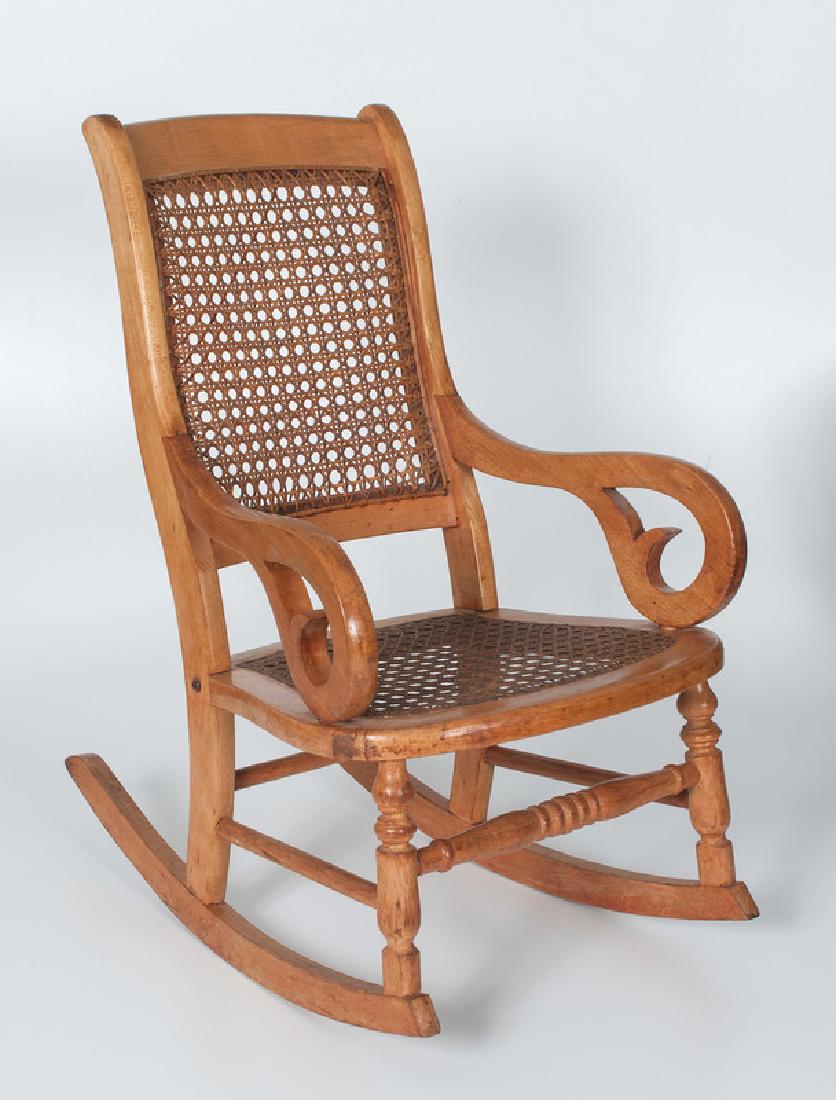 Child's Bentwood Rocking Chair: American. A child's bentwood rocking chair in maple with caned seat and back; oah. 25 in. Provenance: Property from the collection of Katherine Raible, Lexington, Kentucky