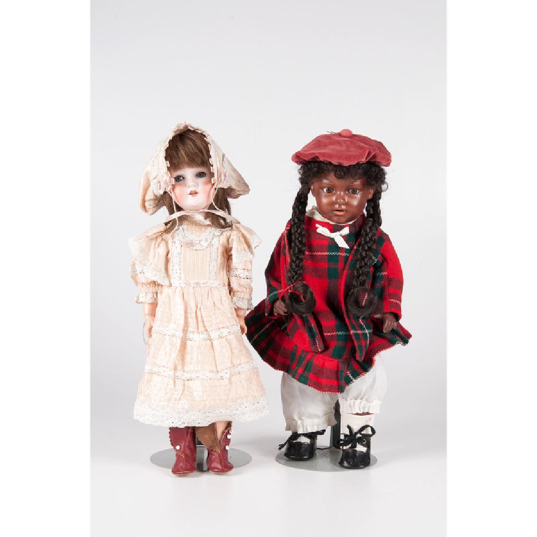 German Bisque Head Dolls: German. Two bisque dolls including a Gebruder Heubach, no 5730, with stand, brown eyes, and open mouth and a C. M. Bergmann, no 1916, with stand, open mouth, and blue sleep eyes; ht. 19 in. (each)