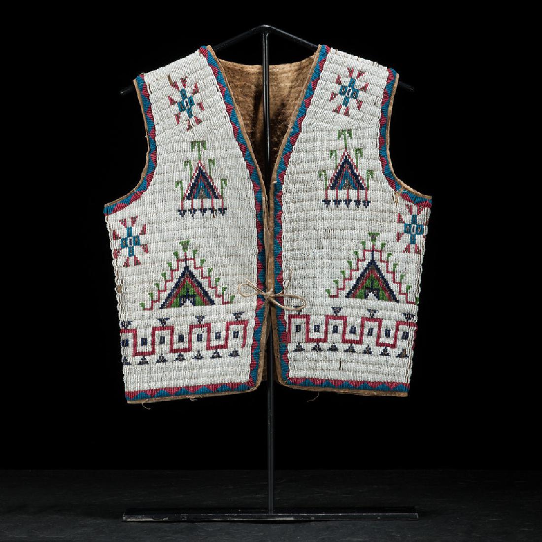 Sioux Beaded Hide Vest, Collected by Gustav (Gus) Sigel: sinew-sewn and beaded using colors of white, pony trader blue, red white-heart, cobalt, pea green, and marcasite, length 16 in. x width 16 in. fourth quarter 19th century Provenance: Gustav (Gus) Sige
