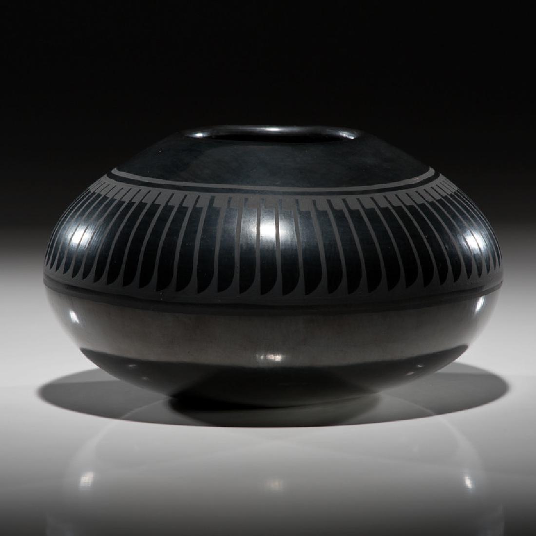 Crucita Calabaza, Blue Corn (San Ildefonso, 1920-1999): large form crafted with a wide body and gently tapered opening; repeating feathers wrap around shoulder, signed on base, height 6 in. x diameter 9.5 in.mid-20th centuryIncluded is a First Prize ribbon