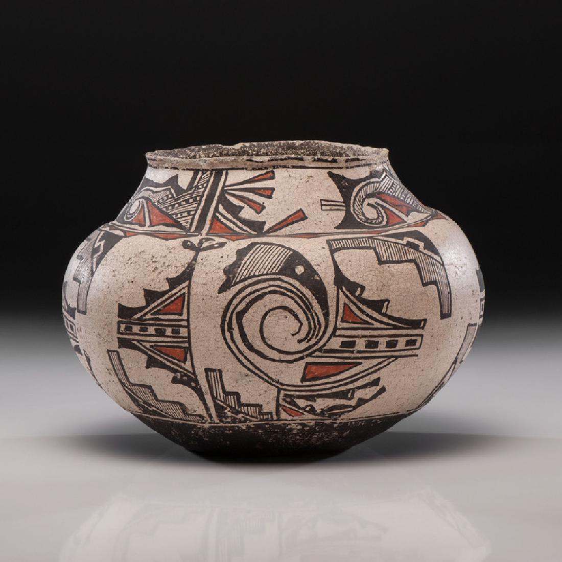 Zuni Polychrome Pottery Jar: with concave base and rounded shoulder; body of jar painted with a unique design of stylized rainbirds intermingling with a variety of geometric elements, height 8.5 in. x diameter 11.5 in. late 19t