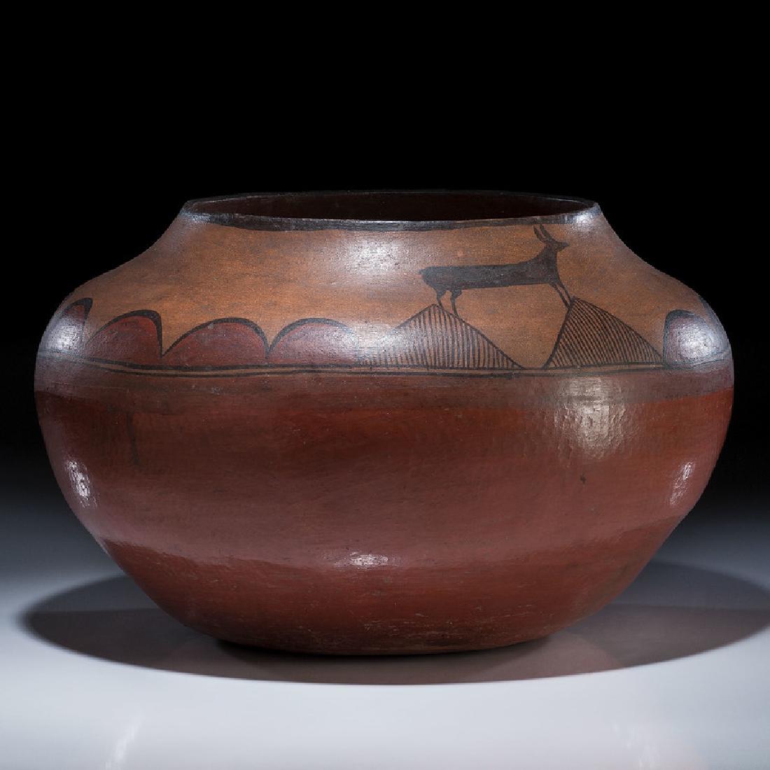 Zia Pictorial Pottery Olla, From the Collection of: of substantial size, decorated with two deer straddling triangular-shaped mountains, height 11 in. x diameter 18.5 in. late 19th century