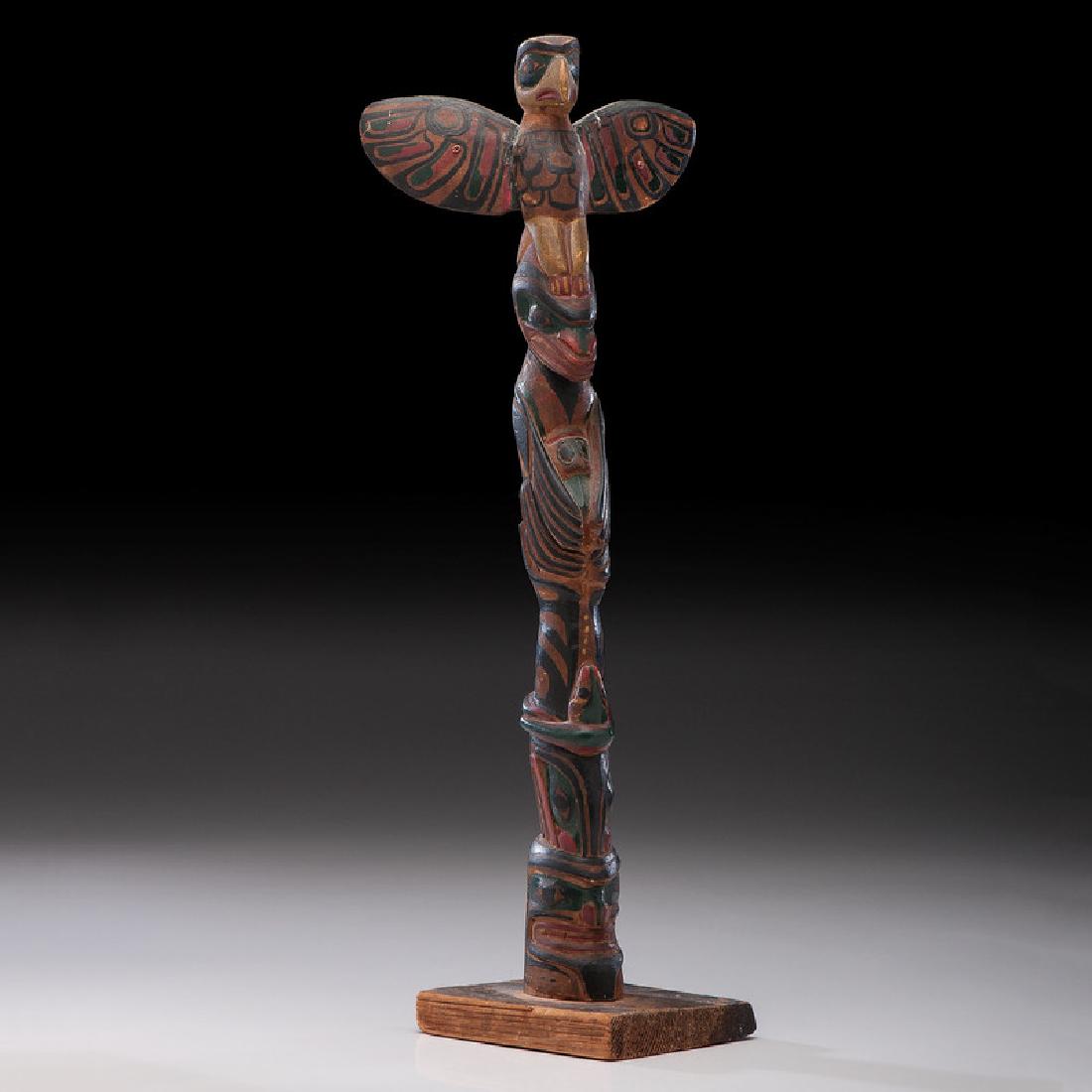 Northwest Coast Carved Wood Model Totem Pole: four-figure carving painted in yellow, red, black, and green, height 20.75 in. second quarter 20th century