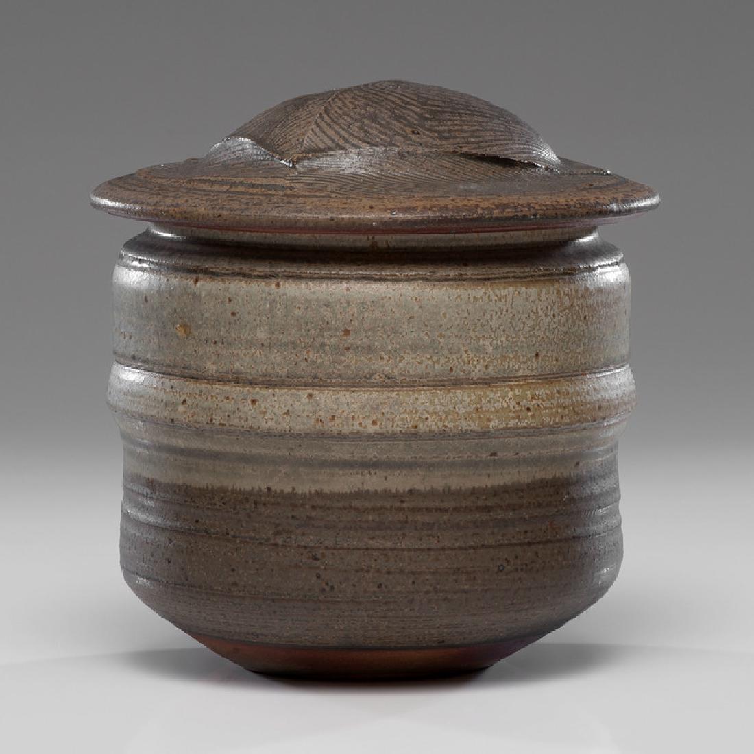 Karen Karnes (American, 1925-2016): Lidded Vessel wood-fired stoneware artist incised KK stamp on base ht. 9, dia. 8.25 in. This Karnes vessel has a combed glaze decoration on the lid.