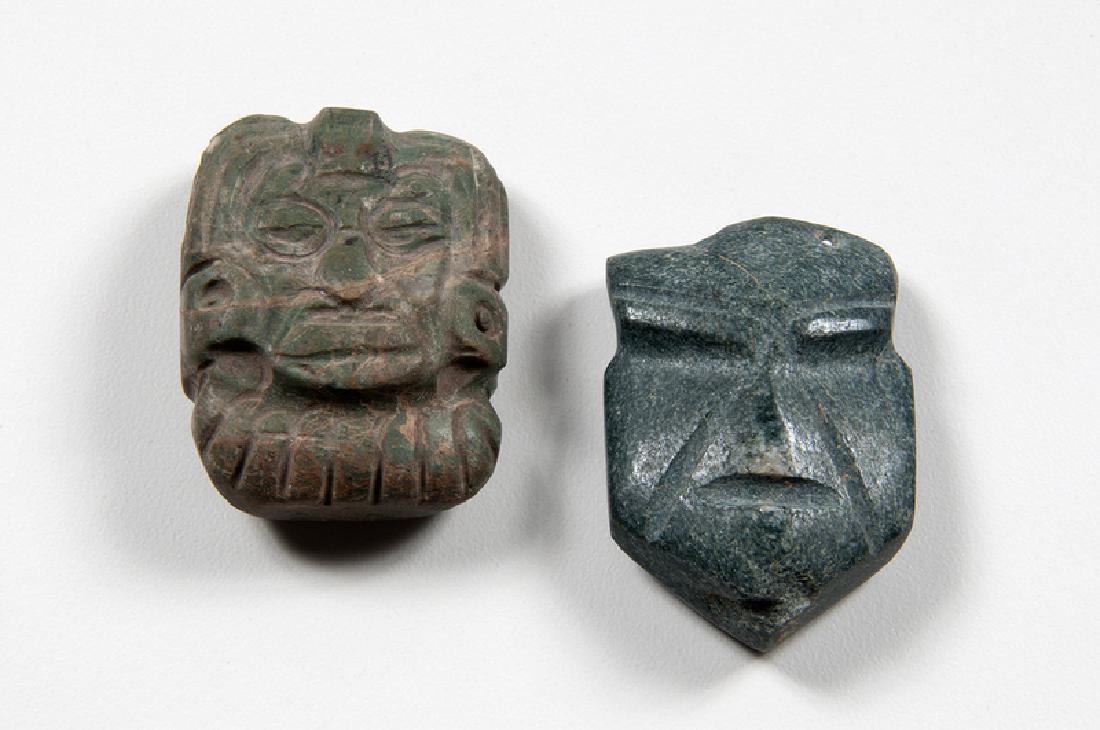Mezcala Stone Pendants: Mexico, pre-Columbian. A group of two Mezcala stone head pendants, including one in flattened block form and one green with headdress features; each approximate ht. 1.5, wd. 1.75, dp. 0.75 in. Provena