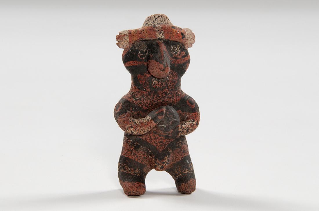 Jalisco Pottery Male Fertility Figure: Mexico, Jalisco, pre-Columbian. A pottery fertility figure depicting a standing male decorated in red and black paint; ht. 4.5, wd. 2.25, dp. 1 in. Provenance: Collection of Ruth Begun
