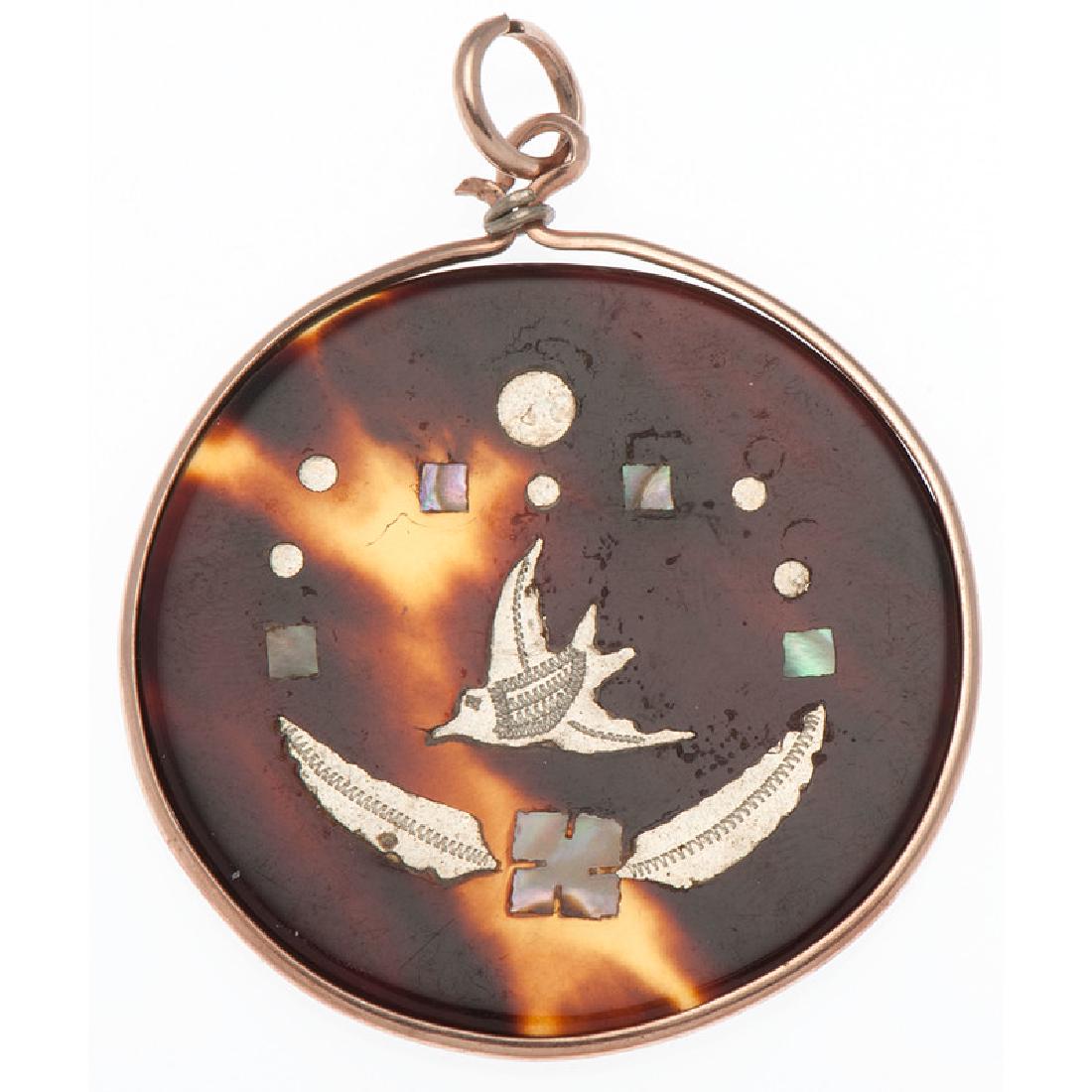 9 Karat Gold Victorian Piqué Pendant: Containing abalone and silver metal depicting a bird. 1.75" L x 1.25" W. Provenance: A Private Collection, Cincinnati, Ohio