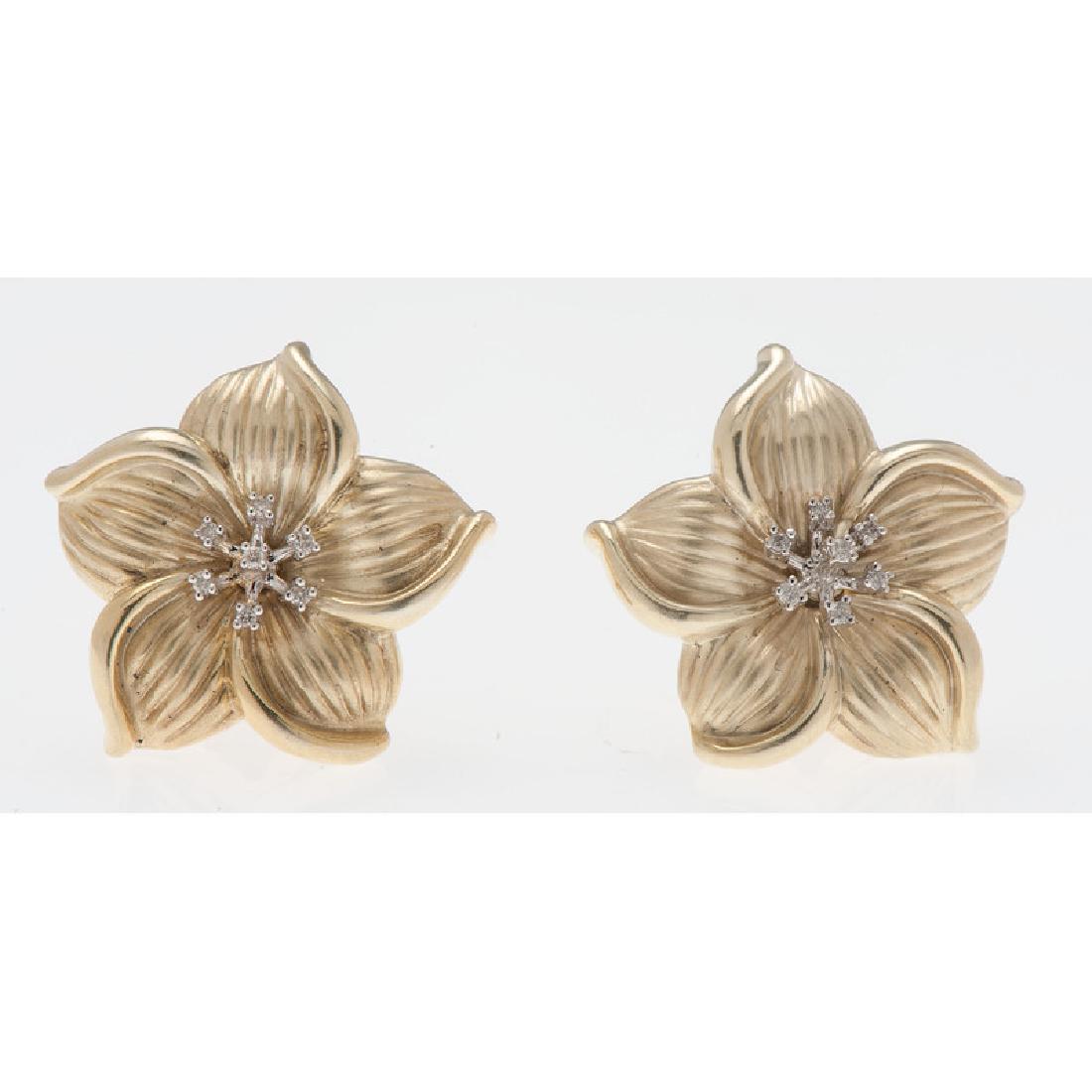 14 Karat Yellow Gold Diamond Earrings: Containing fourteen round brilliant cut diamonds, flower form, omega backs. 0.875" L x 0.875" W. 4.6 dwt.