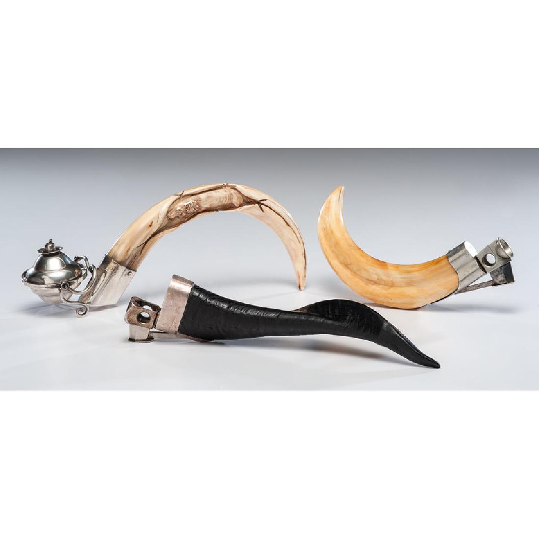 Horn and Tusk Cigar Cutters and Table Lighter Including: Horn cigar cutter is marked Dunhill, Made in Western Germany, 10.5" L x 2" W. Tusk cigar cutter is unmarked, 9" L x 1.5" W. Tusk table lighter is engraved with the front half of a dog, table lighter