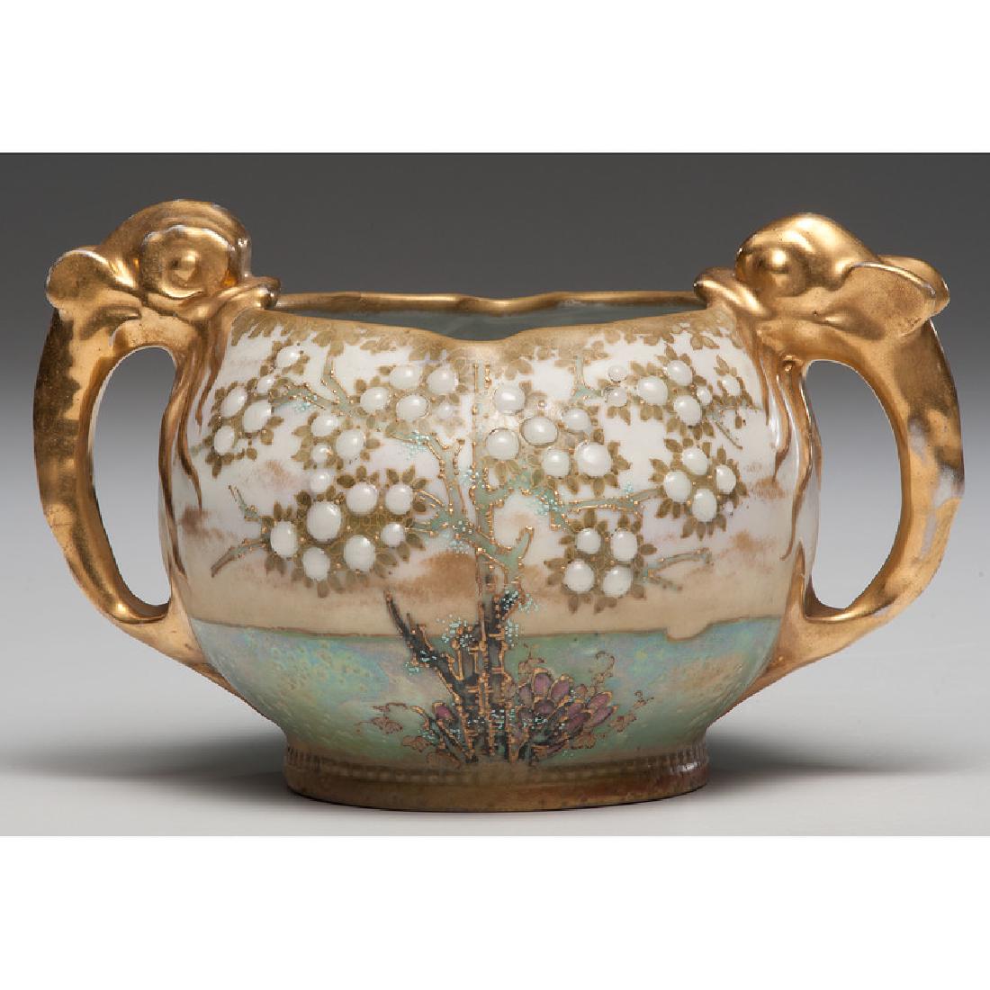 Amphora Vase with Dolphin Handles: Late 19th-early 20th century. An Amphora vase with two gilt handles in the form of dolphins, the bowl decorated with gilt and enamel cabochon trees, impressed marks on underside; oah. 5.25 in.