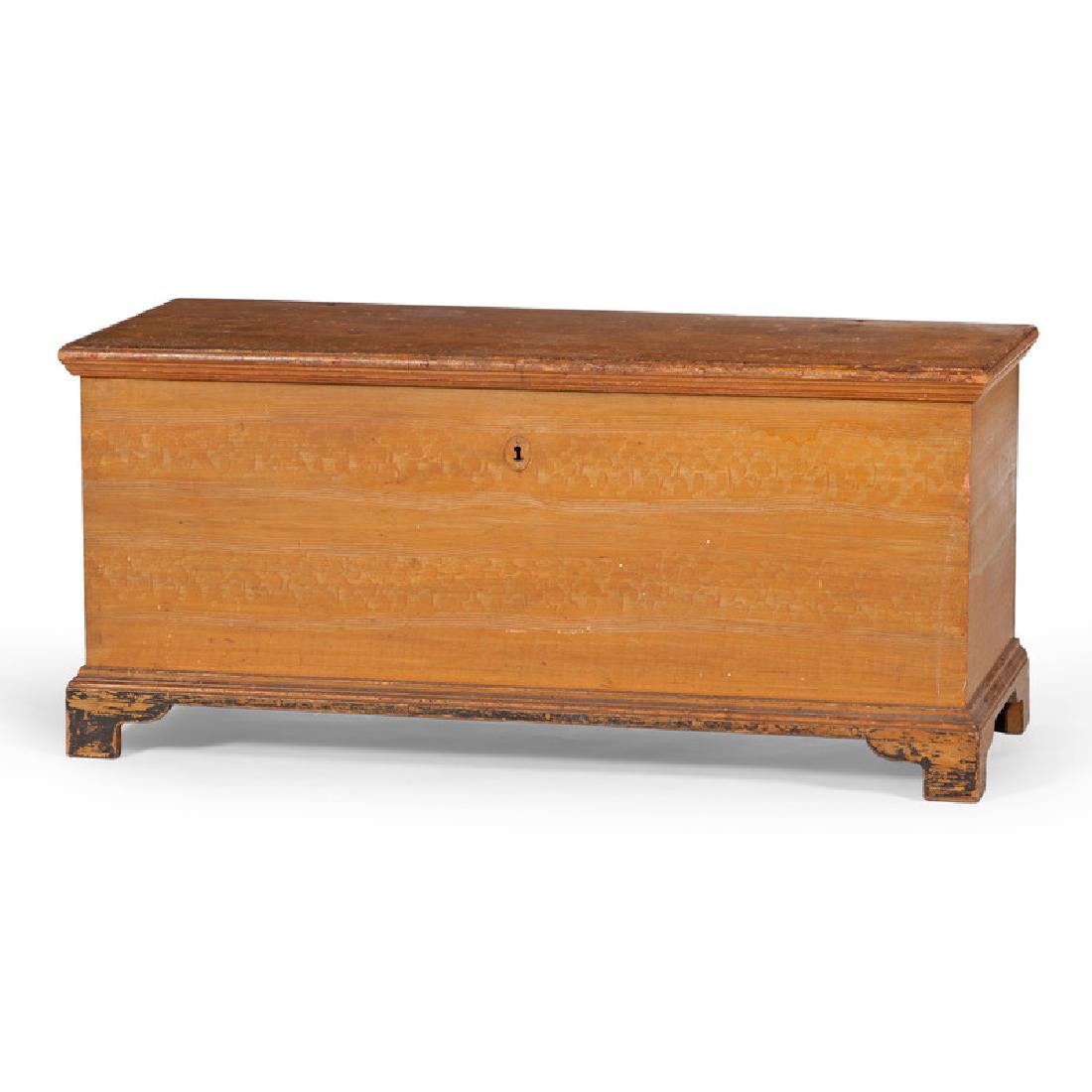 Pennsylvania Painted Blanket Chest: American (Pennsylvania), 19th century. A yellow and green painted blanket chest in pine, having a molded lift top surface, open interior with left till and two secret drawers, the sponge and feather p