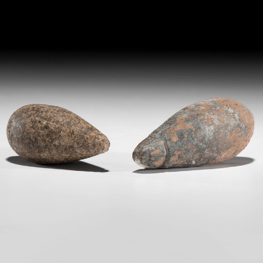 Hardstone Grooved Plummets: Archaic Period, 8000-1000 B.C.lot of 2, longest 3.25 in. Provenance: Publications: Gerber, Art, The Art Gerber Story, 2007, pg. 259, fig. 7.199 Collection History: Art Gerber Catalog Numbers: AG H40 a
