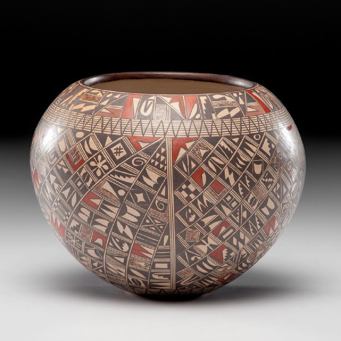 Rondina Huma (Hopi-Tewa, b. 1947) Pottery Jar, From the: decorated with an intricate pattern of various geometric patterns; signed on base, height 6 in. x diameter 6.5 in. late 20th century Also included is a feature article about the artist that appeared i