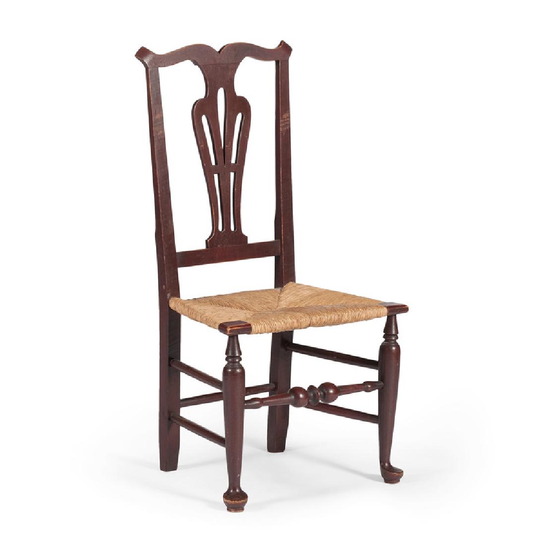 New England Queen Anne Side Chair: American (New England), 18th century. A Queen Anne side chair in red paint, having a yoke crest and pierced splat, above rush seating, turned and tapering legs with turned front stretcher, all rising 