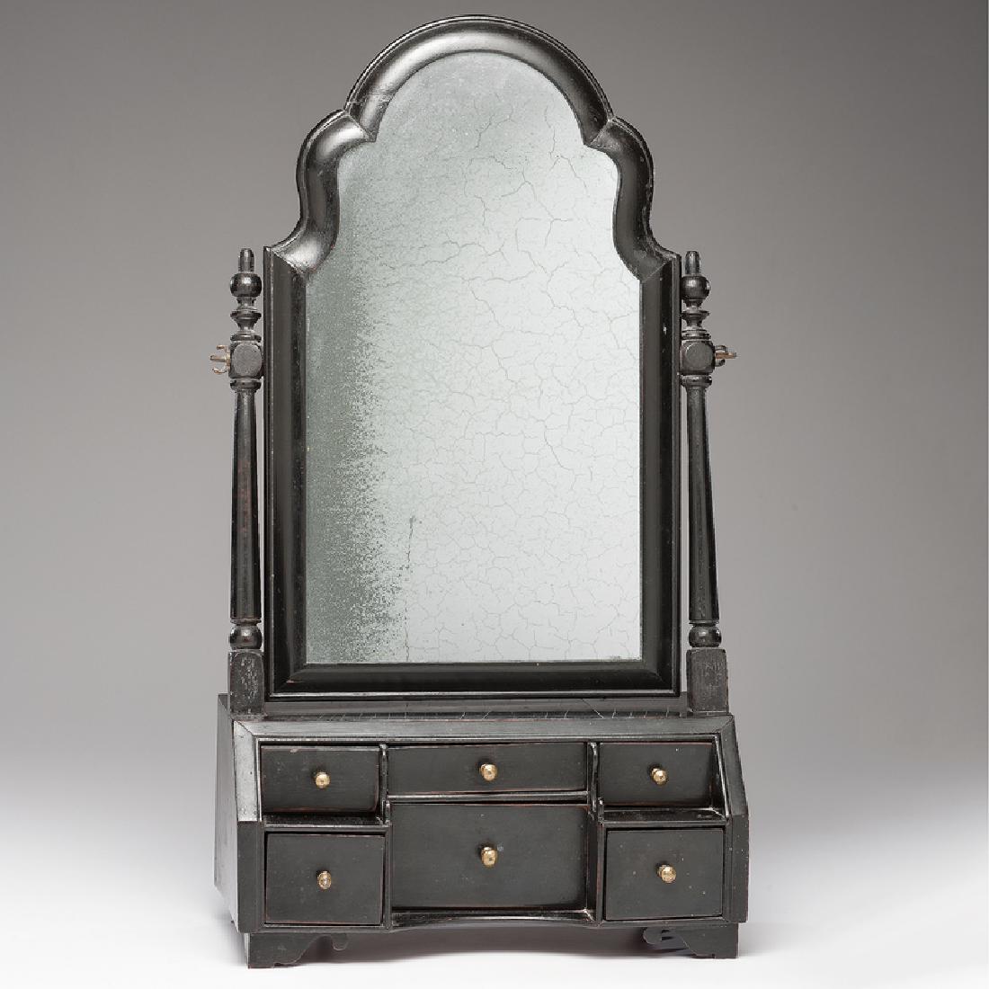 Queen Anne Ladies Dressing Mirror: English, 18th century. An ebonized wood dressing mirror with Queen Anne frame and turned supports, the lower case set with six drawers on bracket feet; ht. 24.5, wd. 13.25, dp. 7 in. Accompanied by le