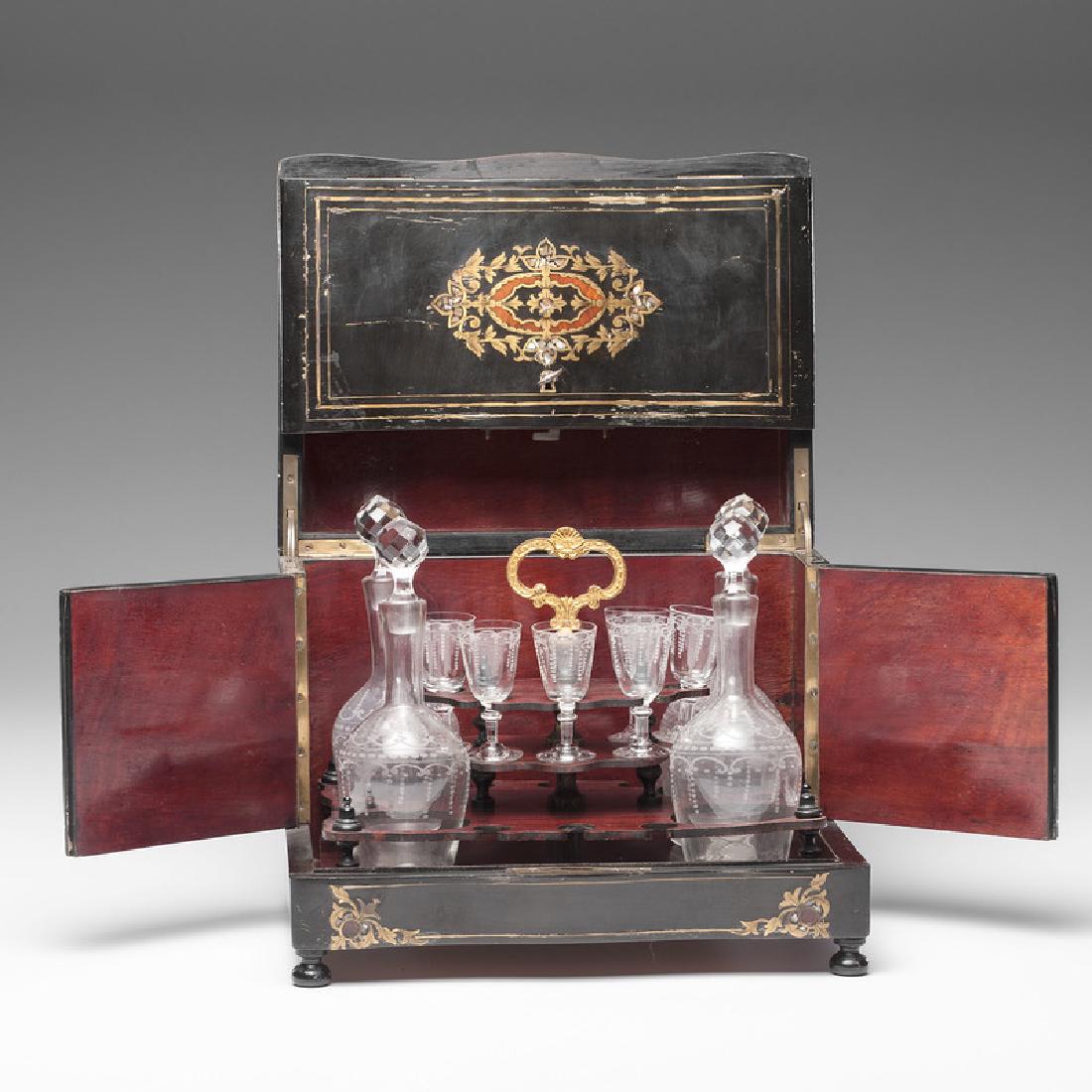 Napoleon III Boulle Tantalus with Etched Glass: French, 19th century. An inlaid tantalus, the finely decorated hinged case opening to reveal a fitted interior holding four etched glass decanters and six etched wine glasses; box ht. 10, wd. 13, dp. 