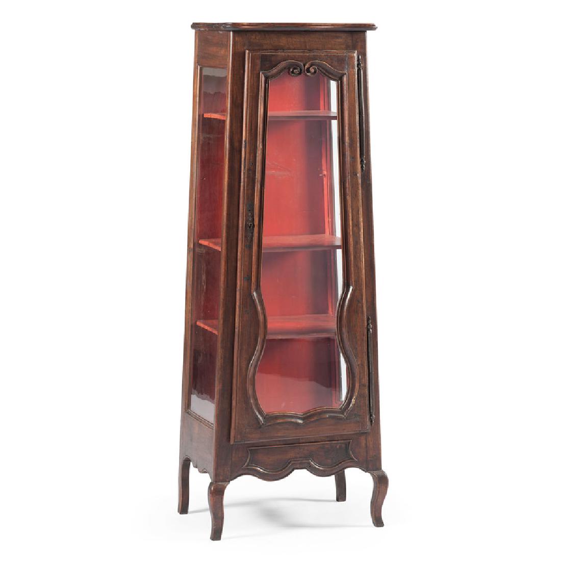 French Provincial Curio Cabinet: French, 20th century. A Provincial curio cabinet in walnut, having a shaped and thumbmolded surface, over an open three shelf cabinet, molded throughout, rising on french cabriole legs; ht. 58, wd. 22