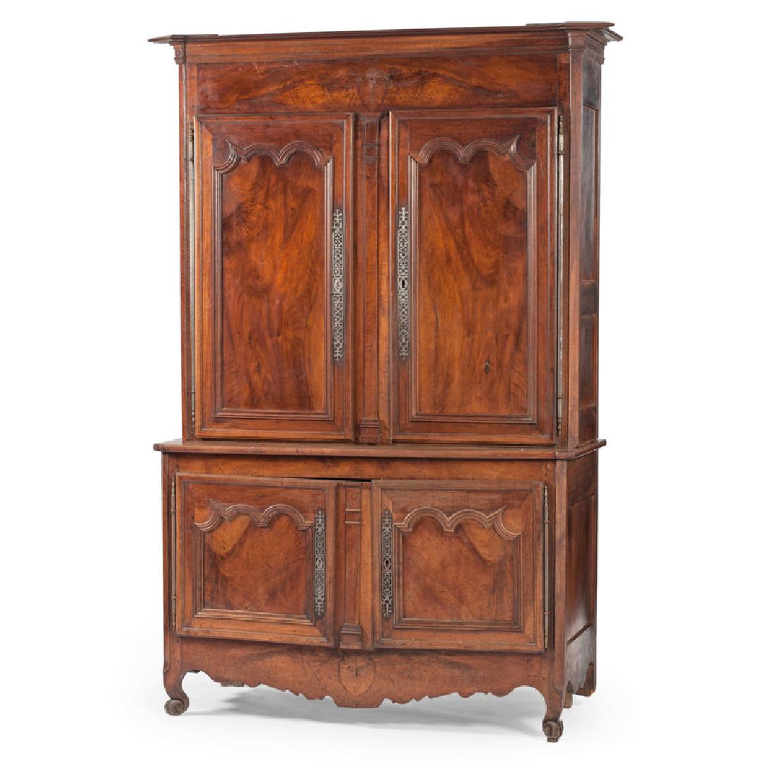 French Provincial Buffet-a-Deux Corps: French, late 19th-early 20th century. A two-piece Provincial buffet in mahogany of peg and paneled construction with canted corners, having a removable molded cornice, over a large upper storage cabin