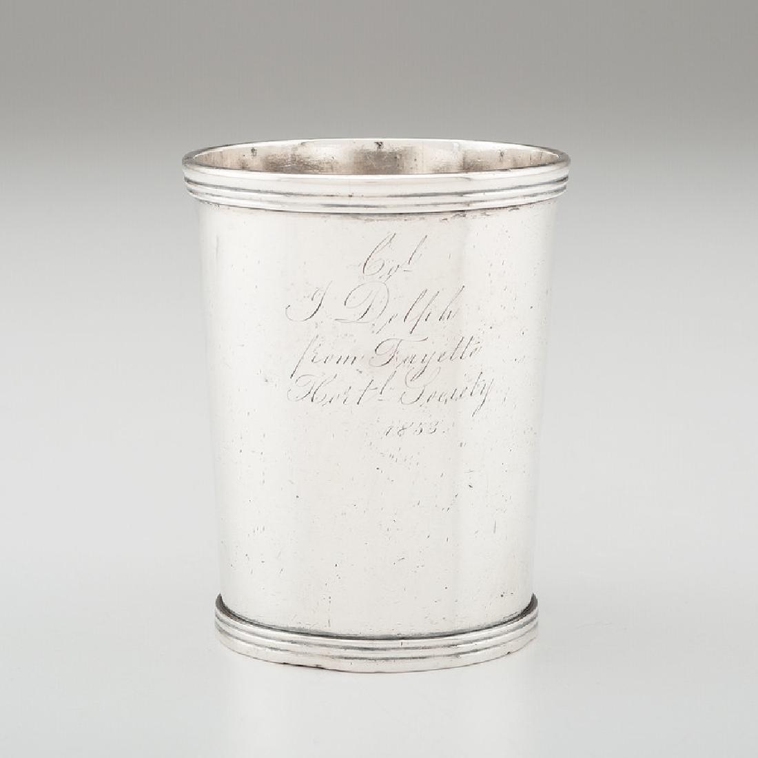 Kentucky Horticultural Society Coin Silver Julep Cup by: American (Lexington, Kentucky), 1842-1862. A coin silver julep cup by Garner & Winchester, engraved Col. / J. Delph / from Fayette / Hortl Society / 1853, impressed marks on underside; ht. 3.75 in., w