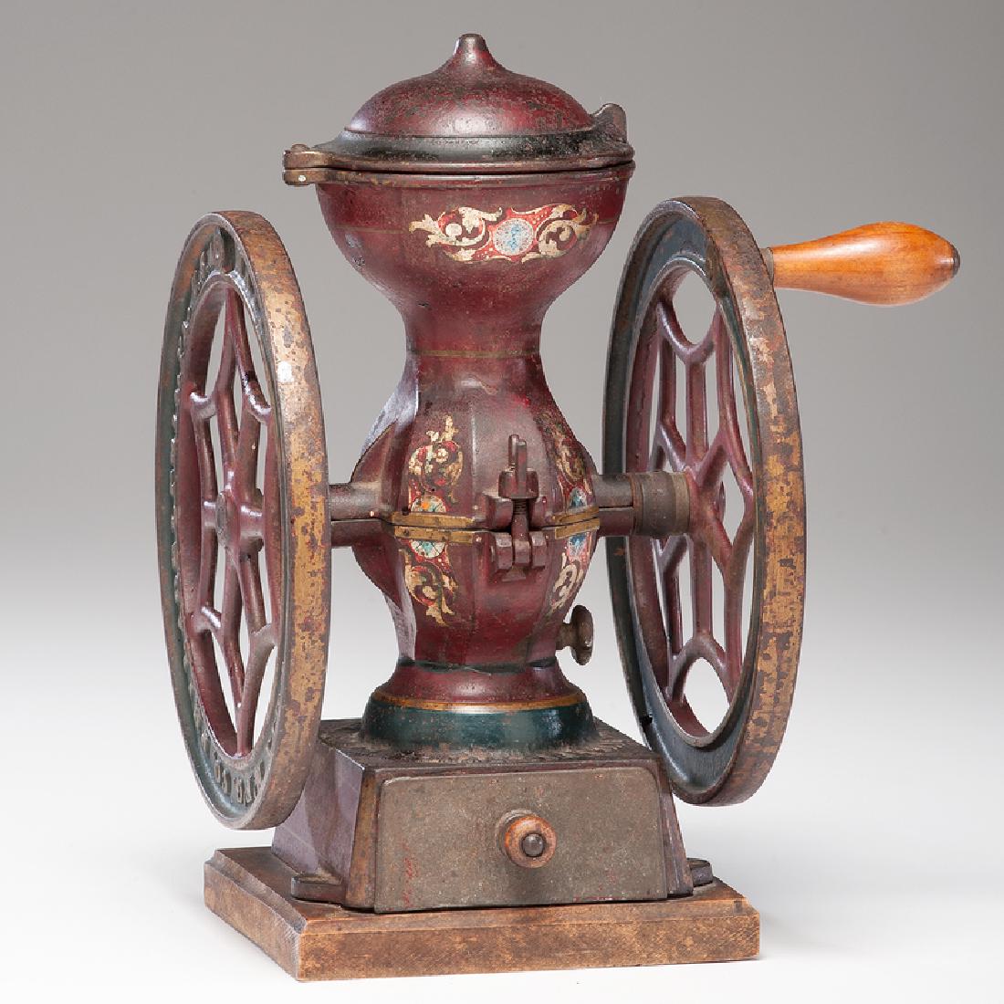 National Specialty No. 2 Coffee Mill: American (Philadelphia), 19th century. A double-wheeled cast iron coffee mill in original paint and decorations, with original hinged lid, secured to wood base, embossed National Specialty M'f'g. Co. 