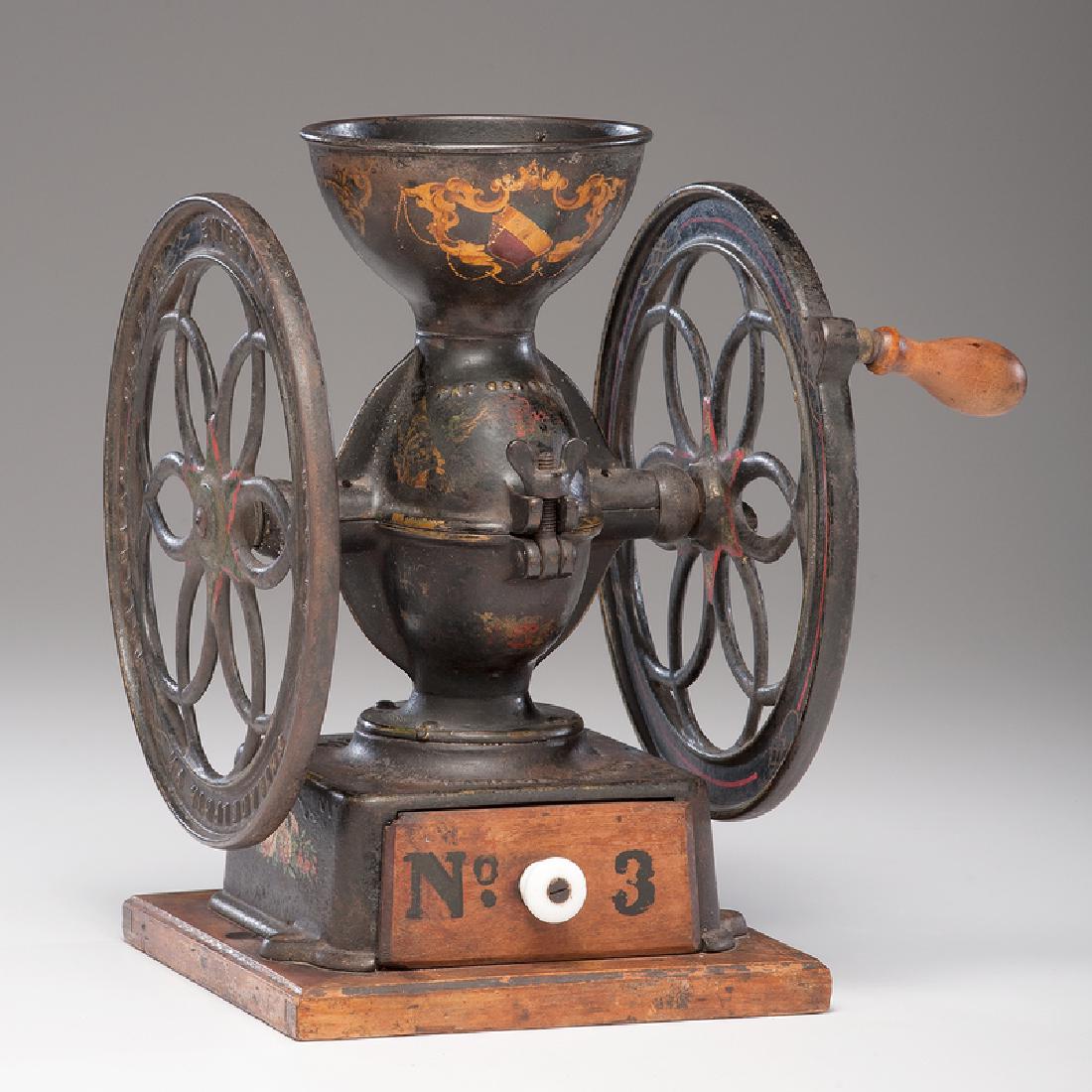 Enterprise No. 3 Coffee Mill: American (Philadelphia), 19th century. A double-wheeled cast iron coffee mill in original black paint and armorial crest decoration, with wooden crank handle, wood base, and wooden drawer with ceramic