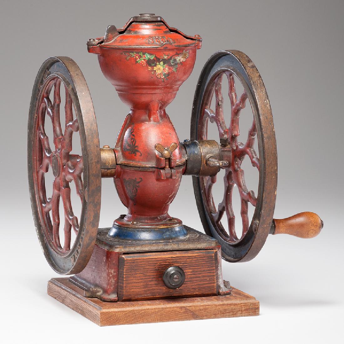 Charles Parker No. 3000 Coffee Mill: American, late 19th-early 20th century. A double-wheeled cast iron coffee mill in original paint, with original sliding lid, secured to wood base, embossed The Cha's Parker Co. / Meriden Conn. U.S.A. 